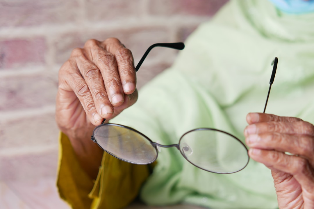 elderly man wearing smart glasses indoors