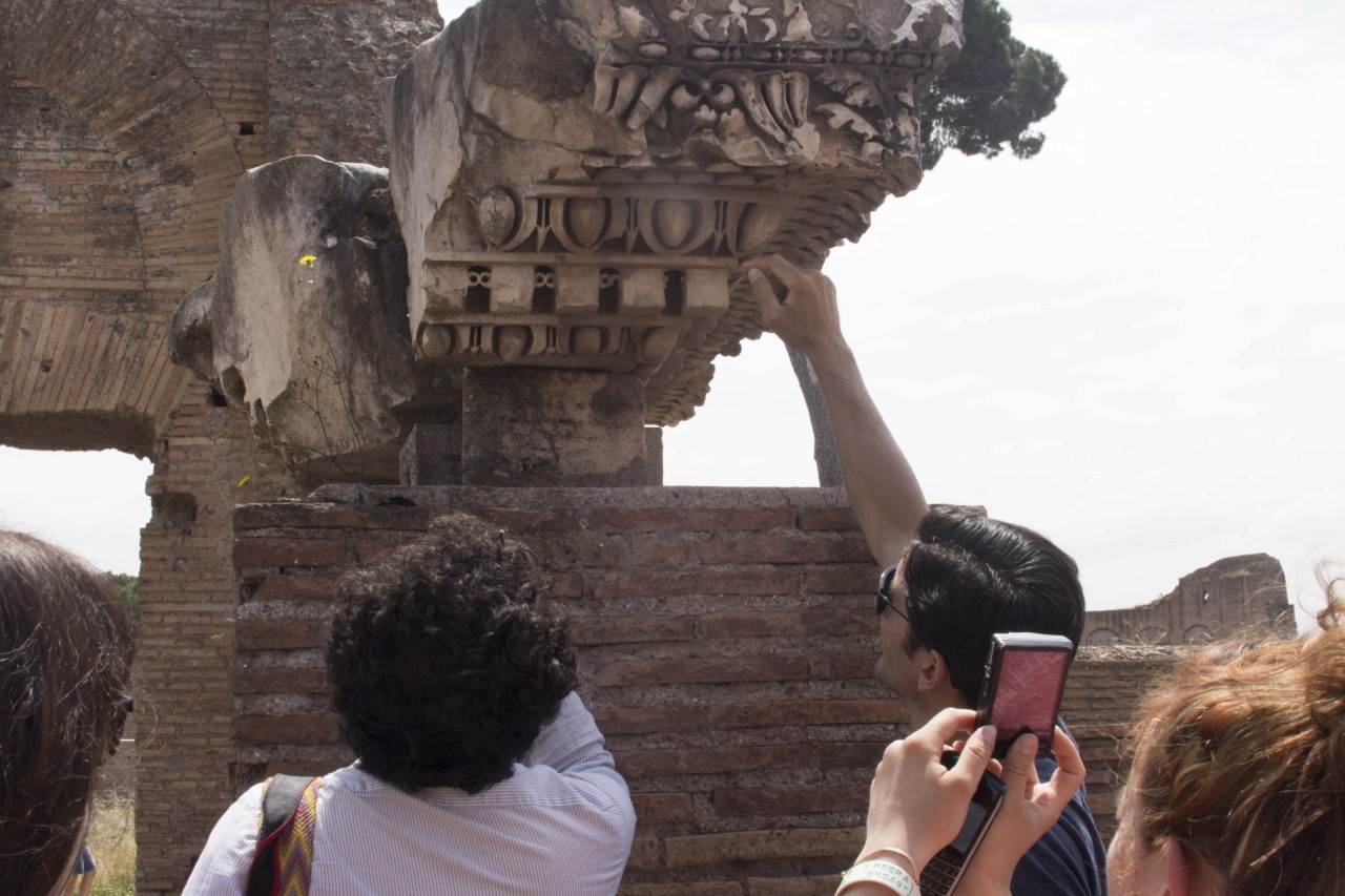 a person touching historical artifact