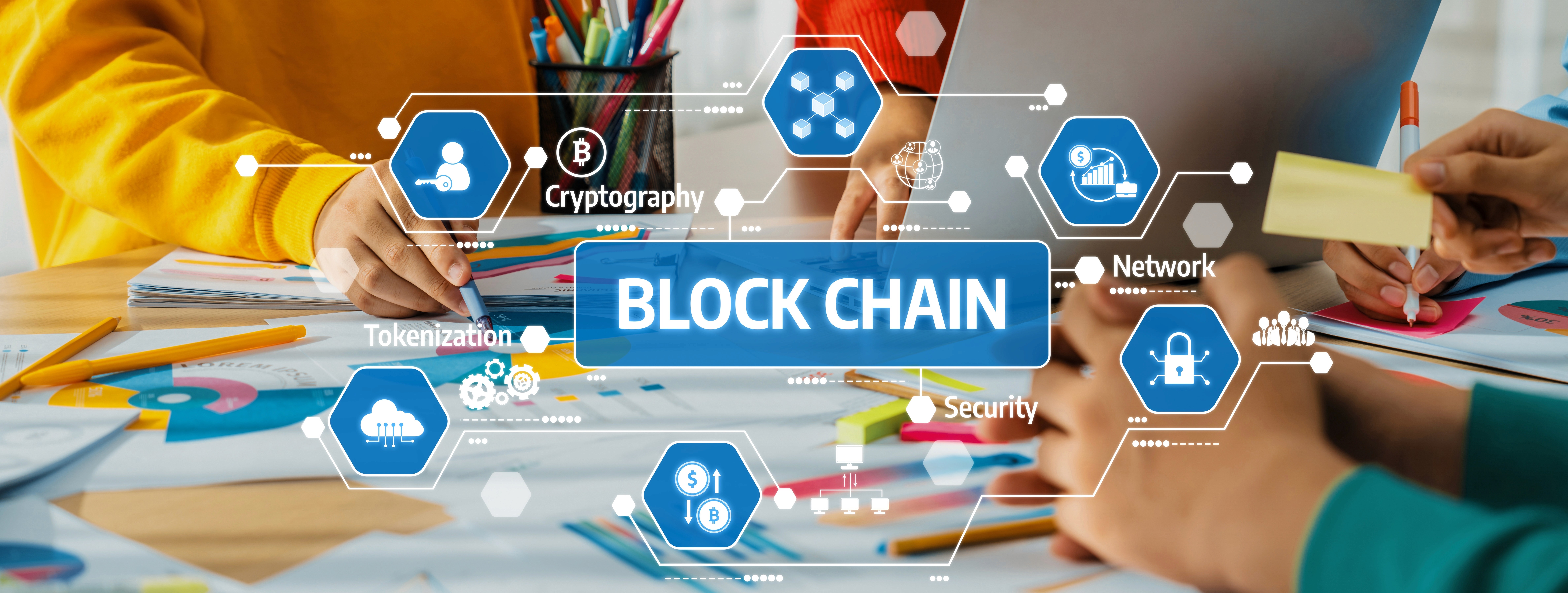 Two colleagues collaborating over paperwork at an office desk, with plants in the background.