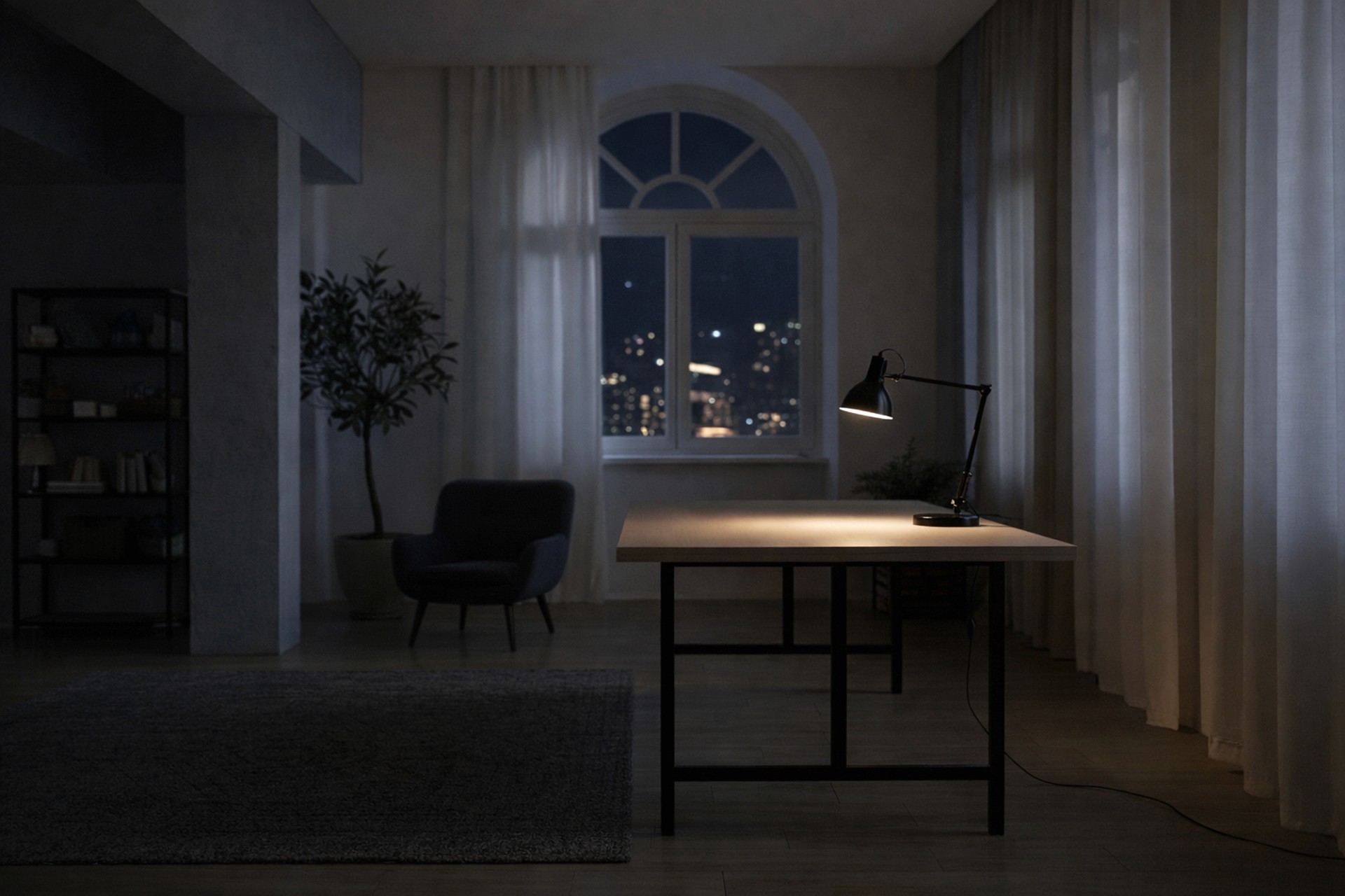 A wide shot of a minimalist, dark studio at night featuring an empty wooden desk illuminated by a single black task lamp.