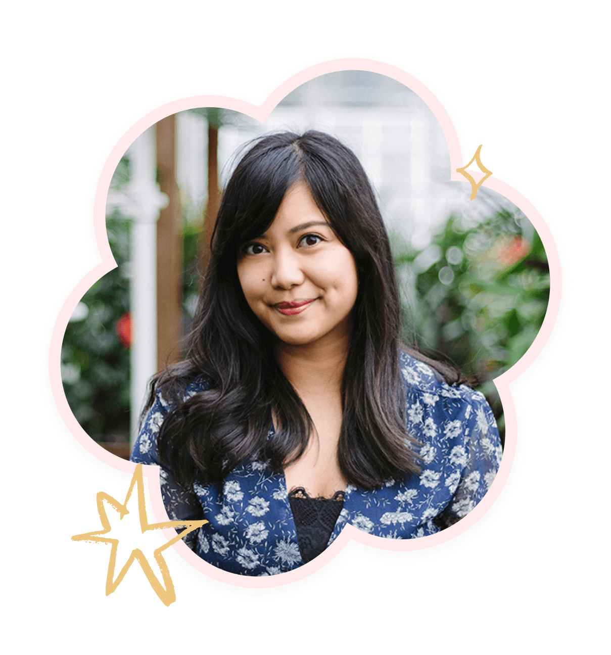 Julie Talosig smiling, photographed against a background of lush green plants