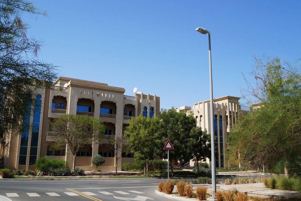 A large building with numerous windows, identified as the Ewan Residence