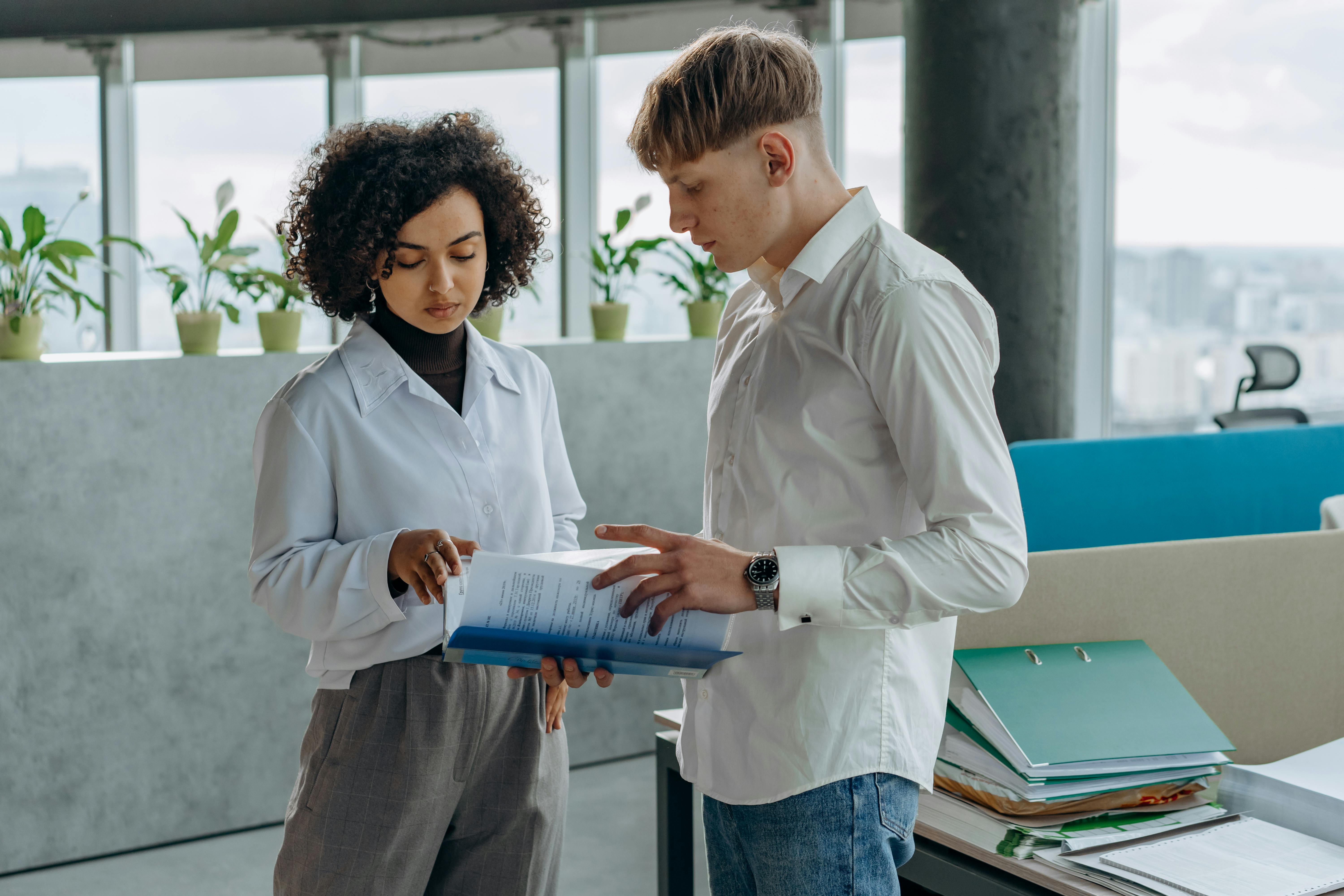 Two people looking together at a document.