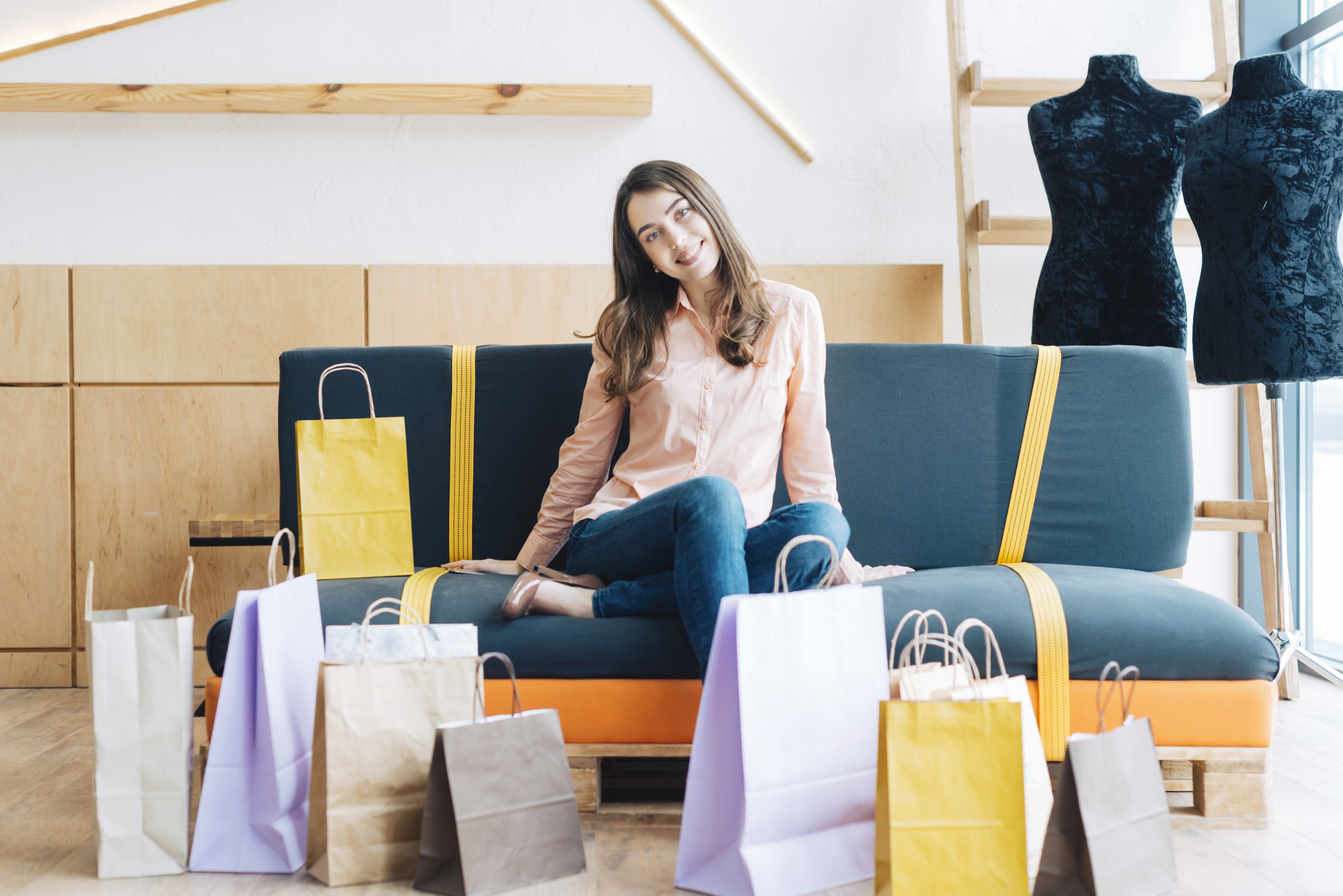 Influencer surrounded by shopping bags, representing curated TikTok Shop collections designed to simplify product discovery and boost affiliate sales.