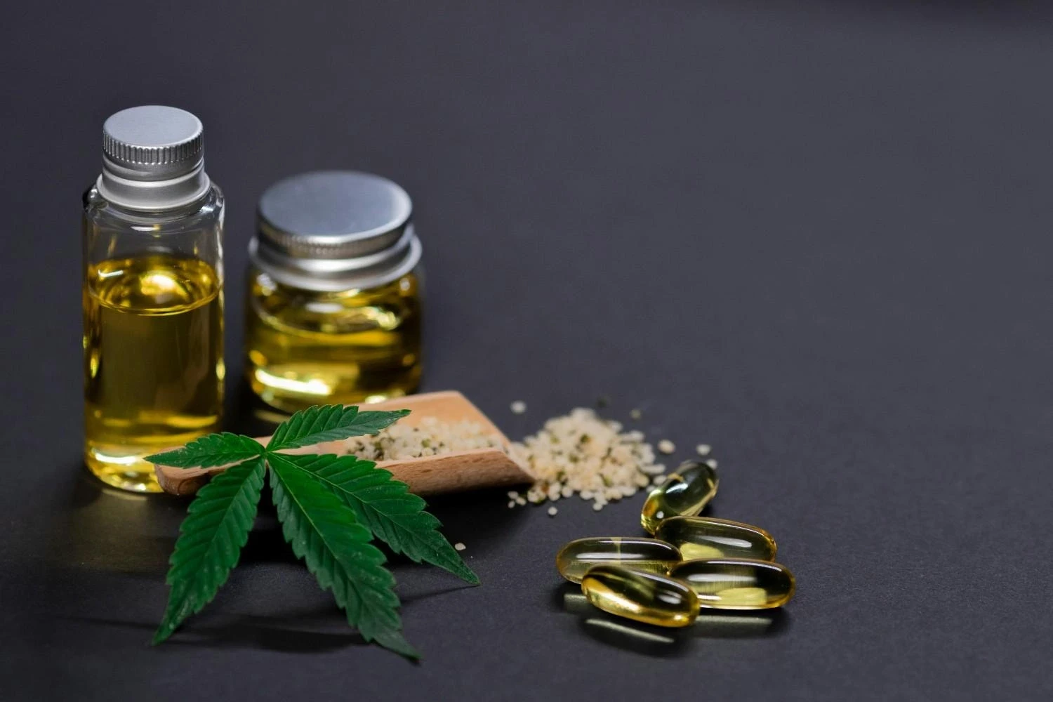 Products representing funding opportunities for cannabis businesses oils, hemp seeds, and capsules on a dark background.