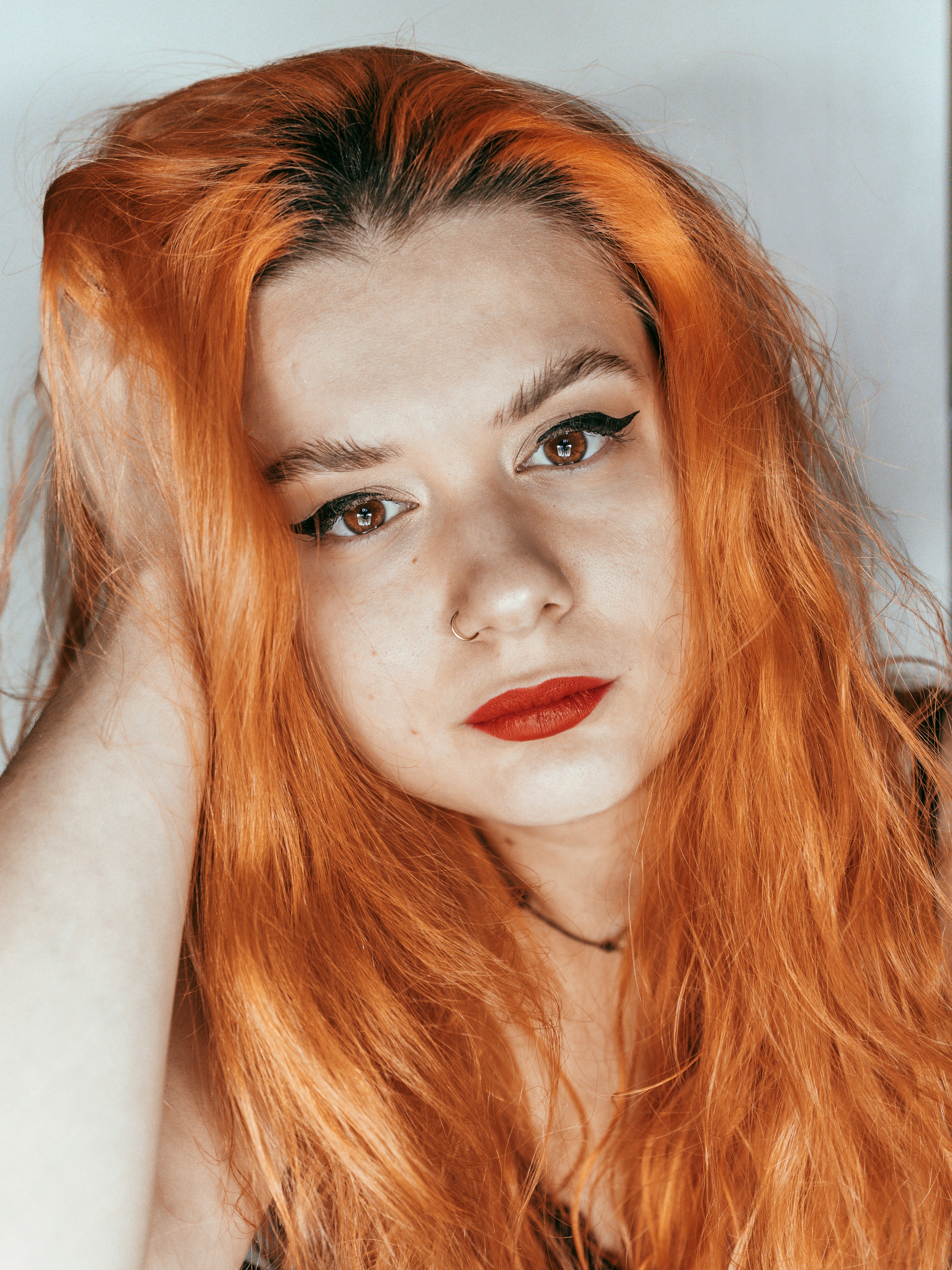 a woman with red hair is posing for a picture