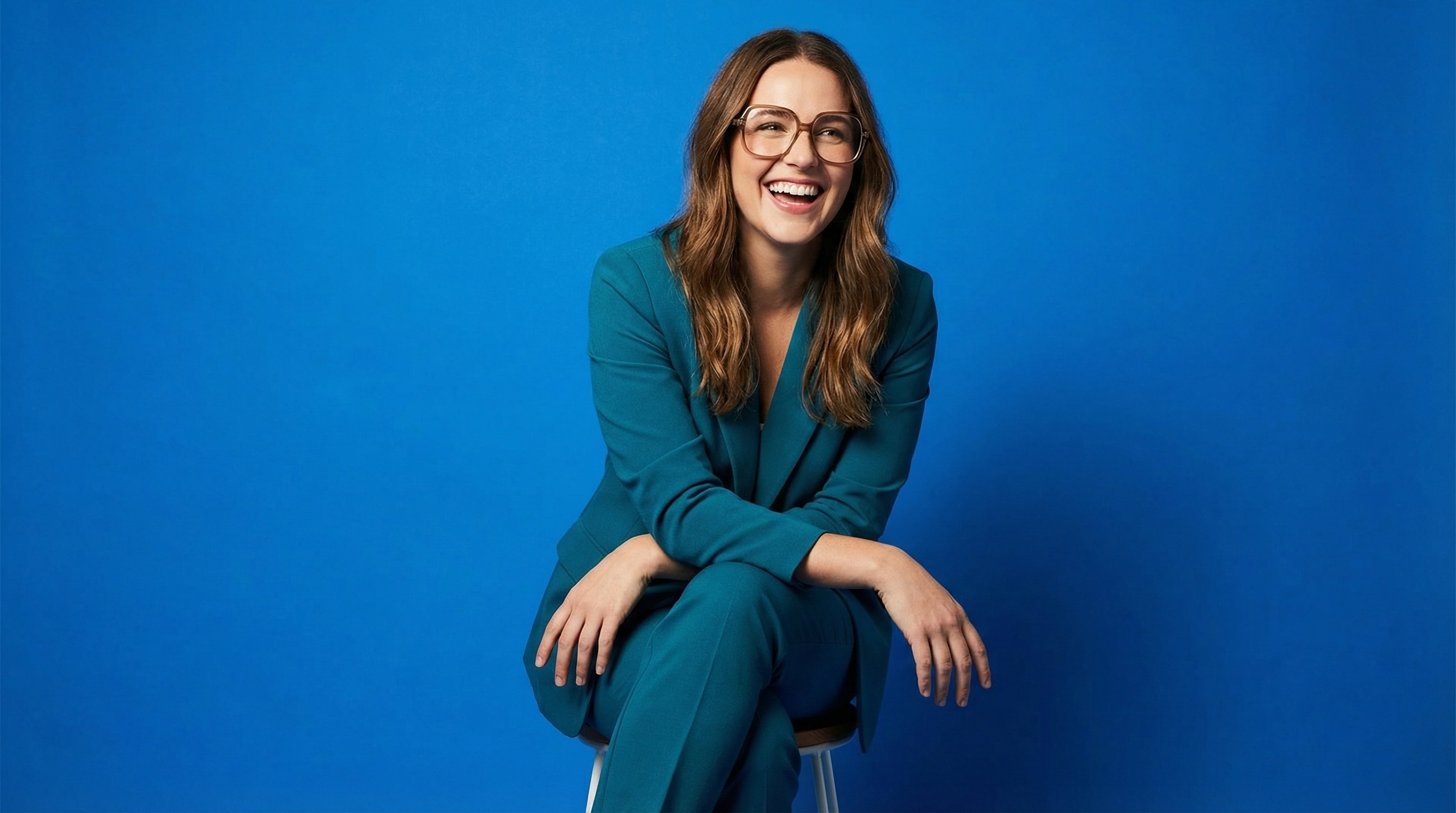 Close-up of lush, dark green leaves, some glossy and wet, against a muted background.