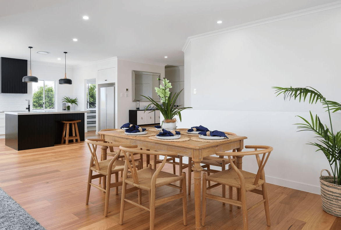 Spacious Queensland living and dining area with timber-look hybrid flooring built for real homes—water-resistant, easy to maintain, and comfortable underfoot.