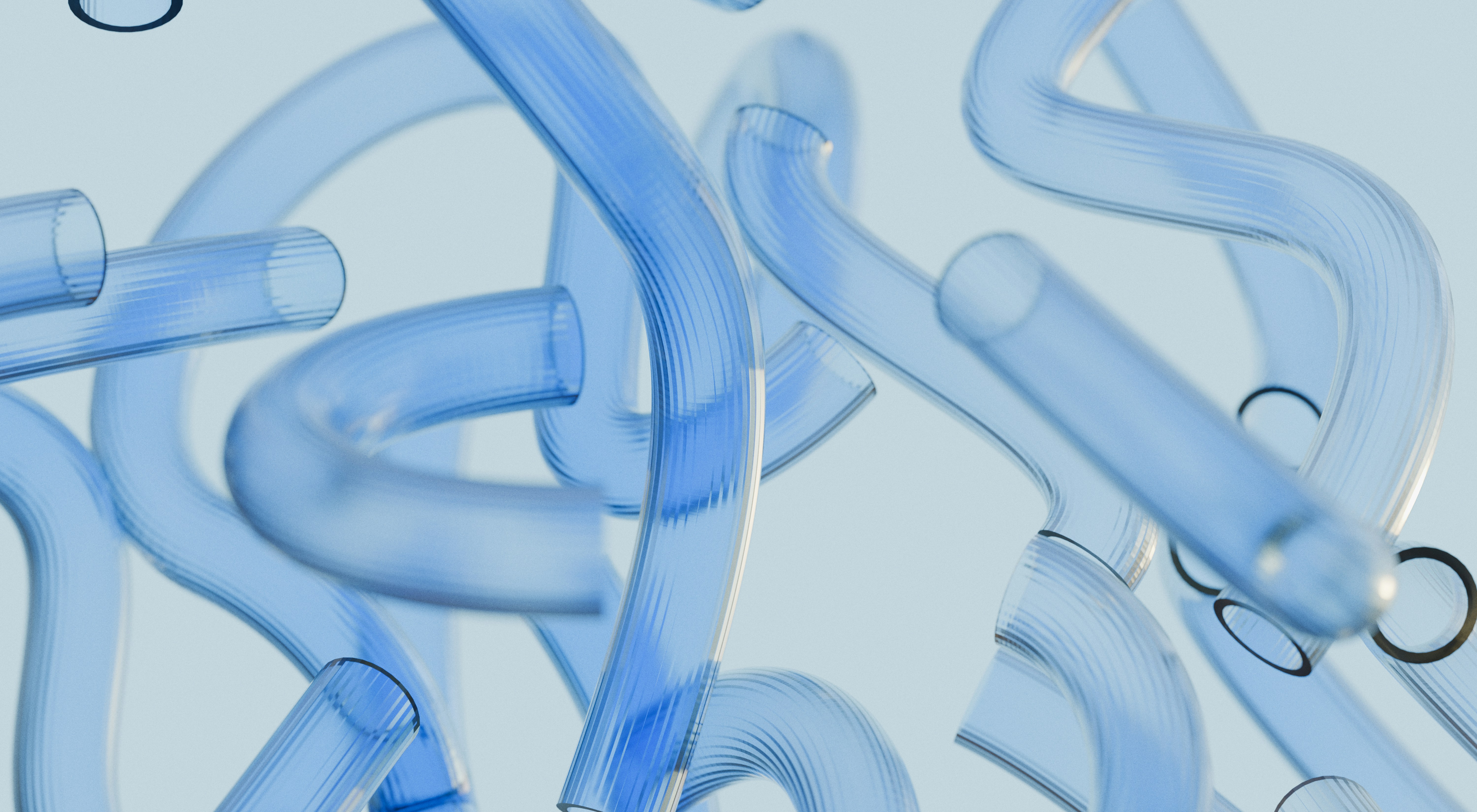 Abstract overhead view of curved and overlapping translucent blue glass laboratory tubes arranged on a pale blue background, representing scientific research and analytical processes at Janera Science.