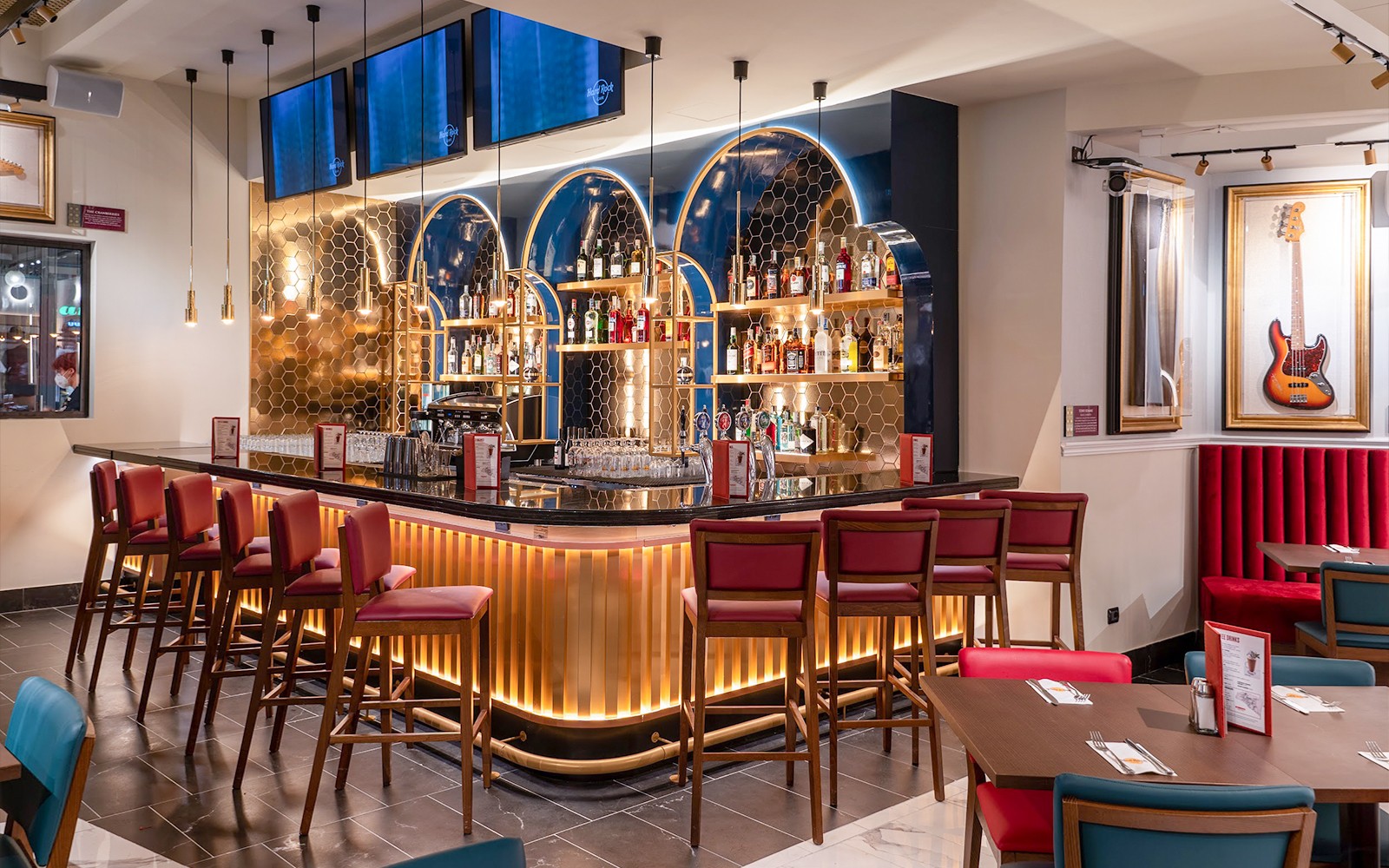 Hard Rock Cafe Milan bar area with seating and guitar decor.