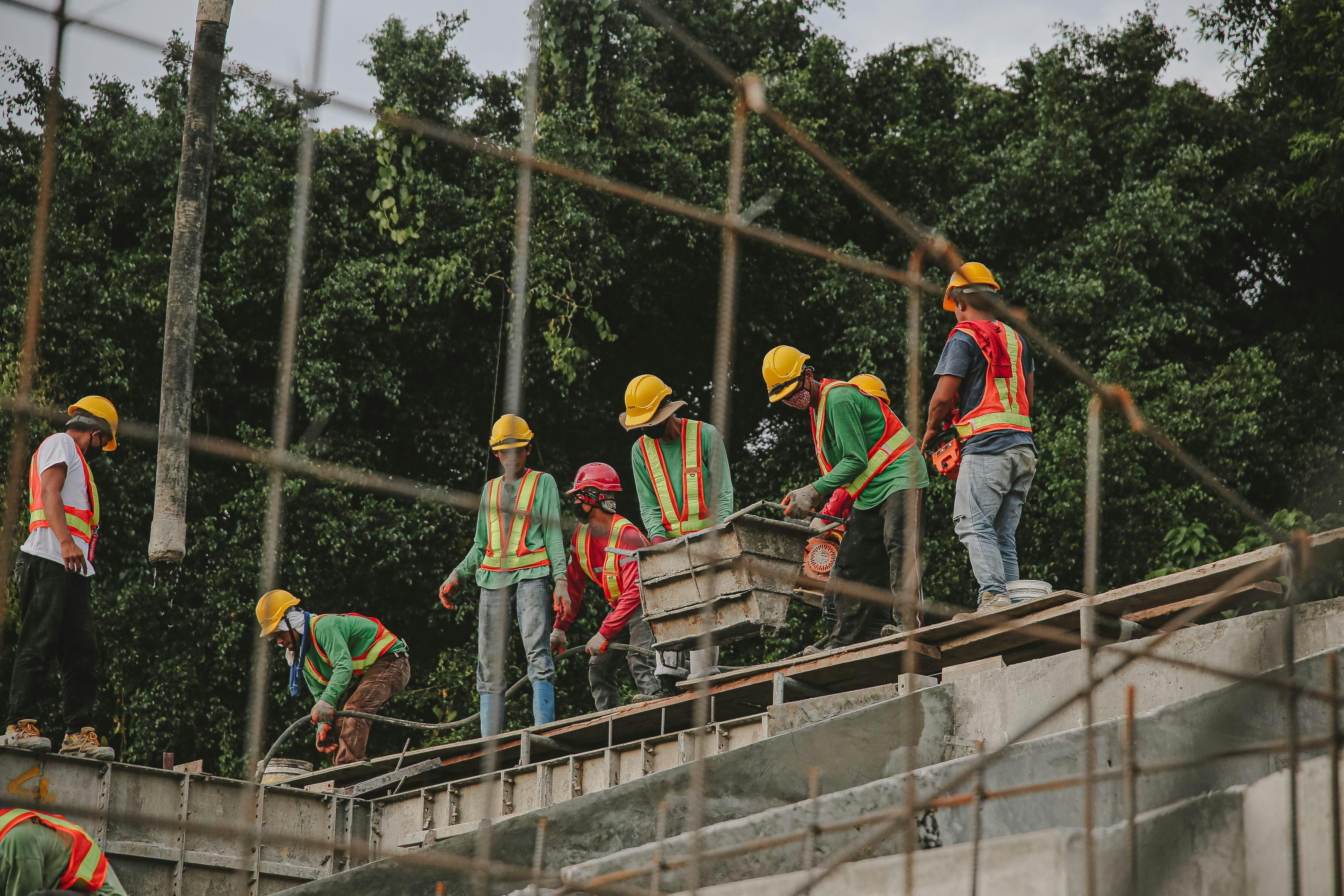three construction workers with helmets