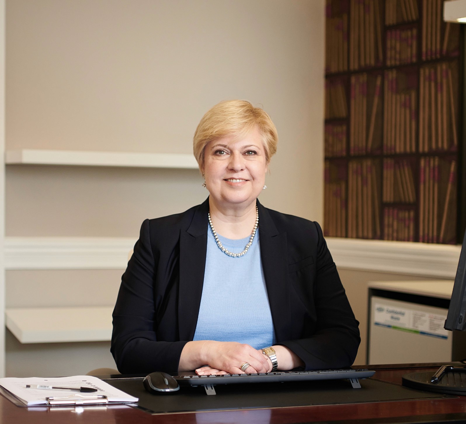 Photo of consultant doctor Eirini Lentari in her clinic office with computer to the left hand side