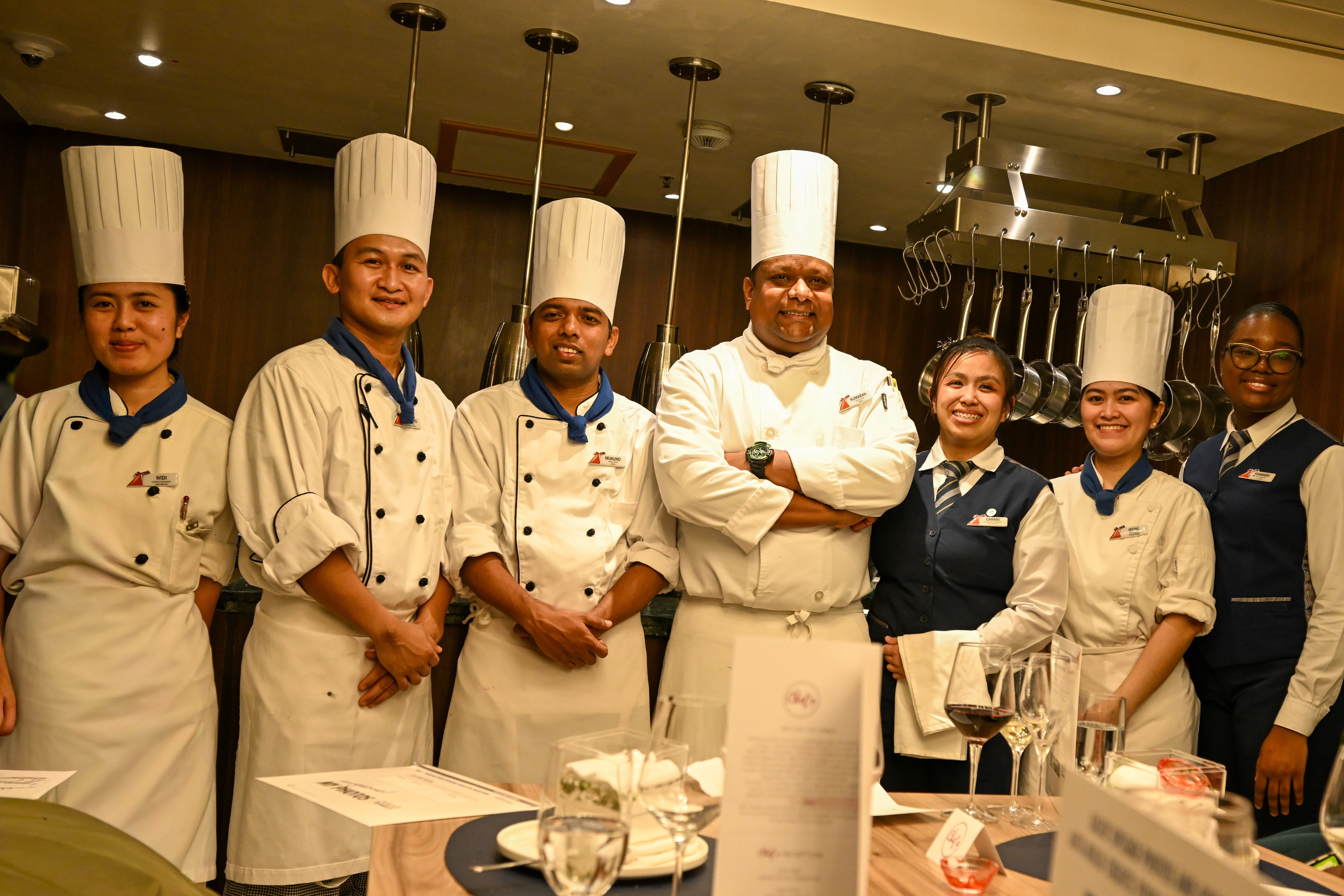 A group of Chefs and servers in a fancy restaurant
