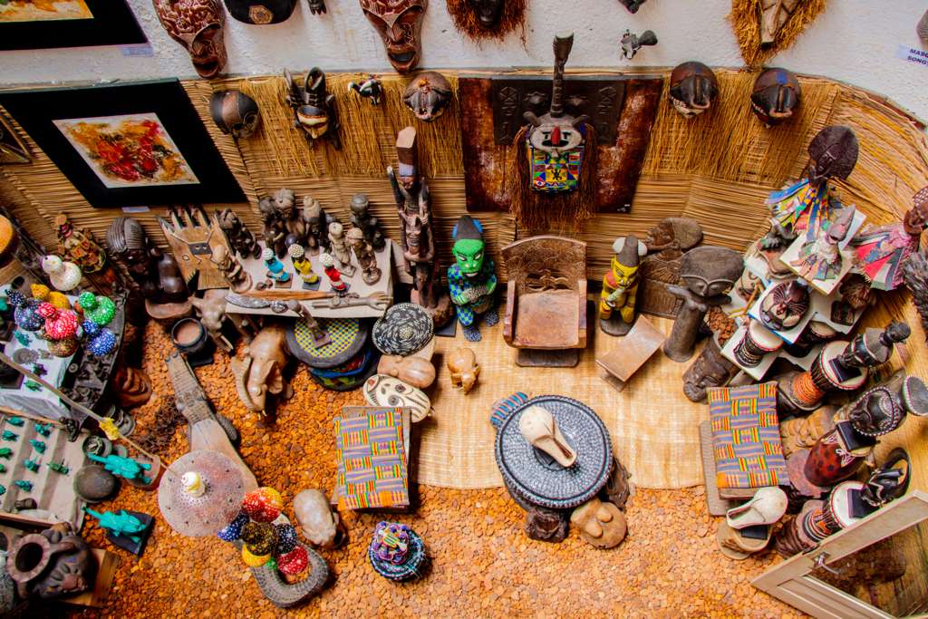 a number of paintings on a wall near one another