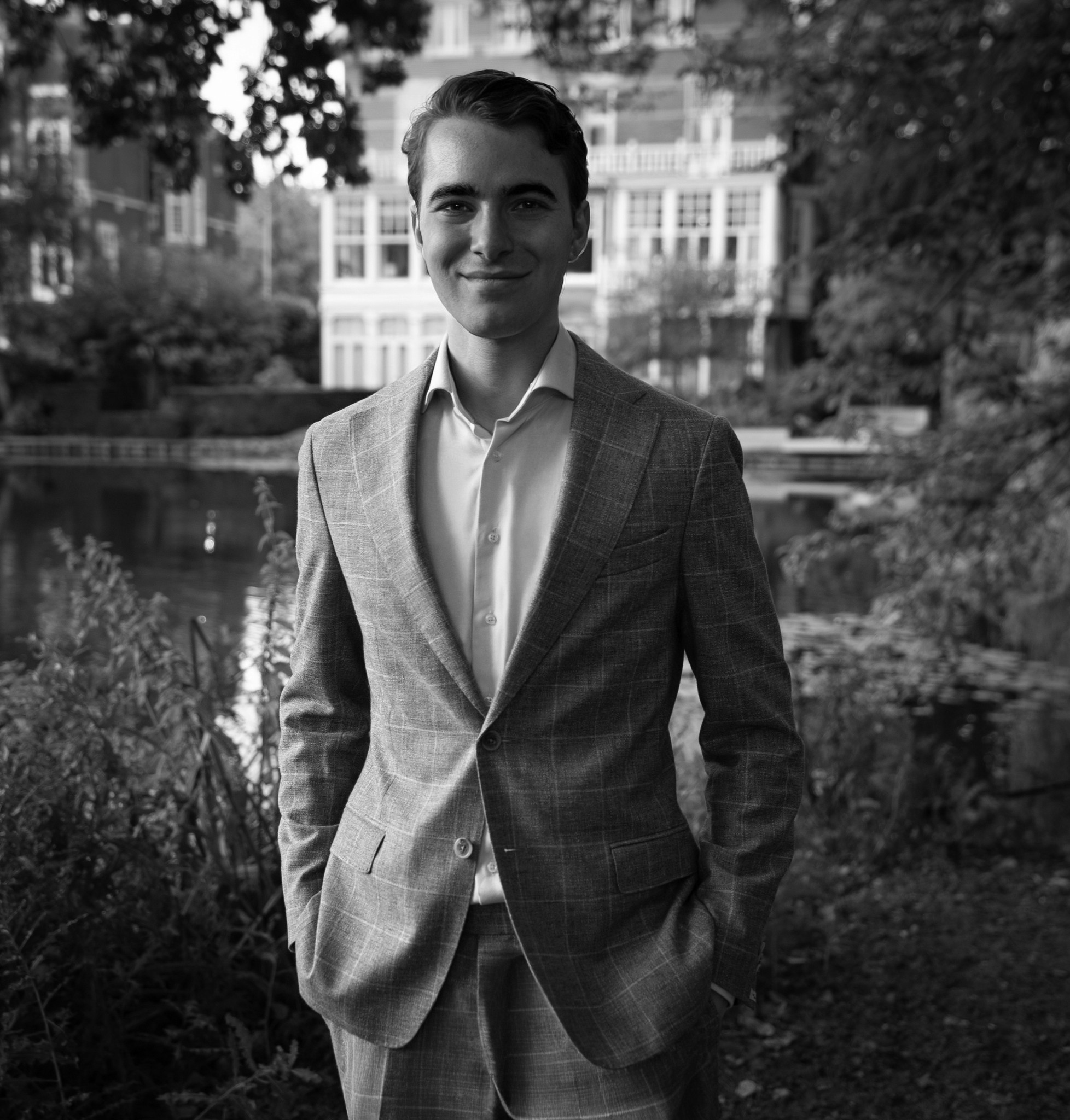 Portrait of a person in dark clothing speaking on a phone