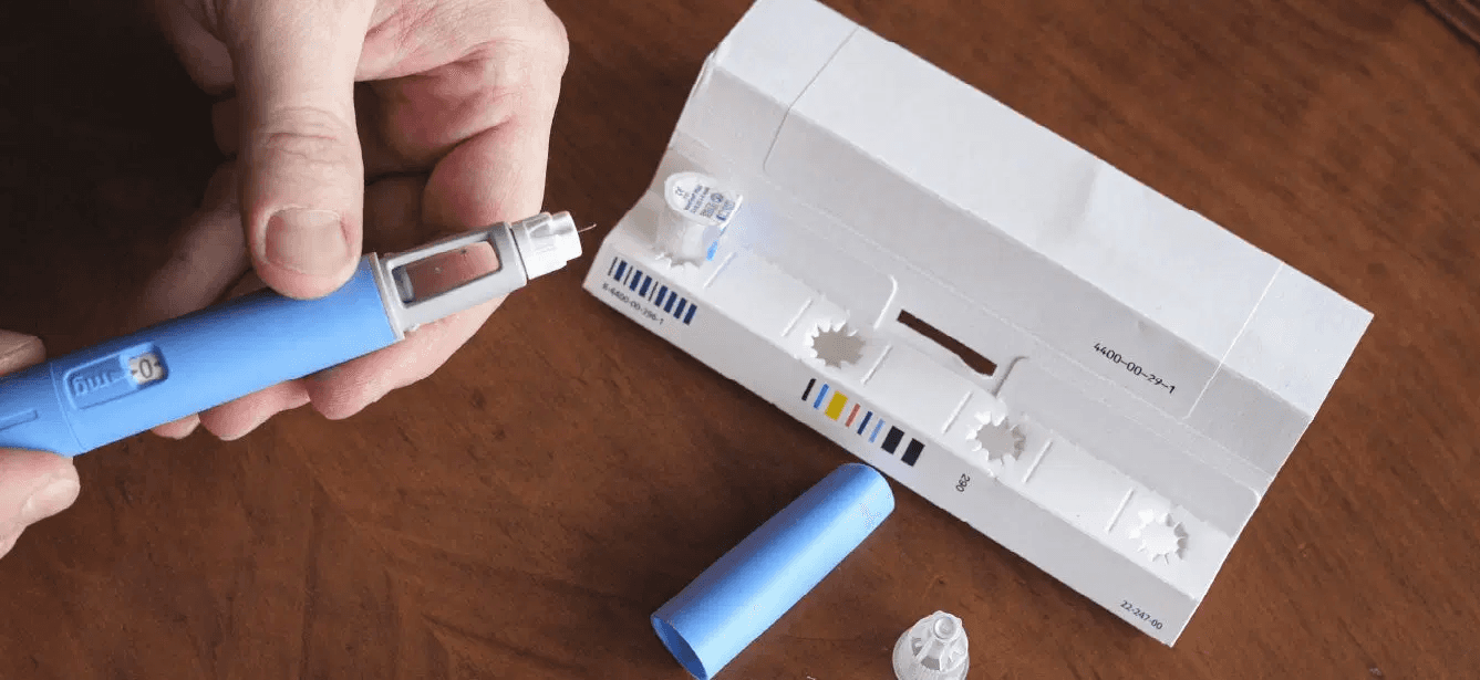 A person holding an injection - Can I Ask My Doctor for Weight Loss Medication