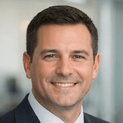 A man standing in front of a window smiling