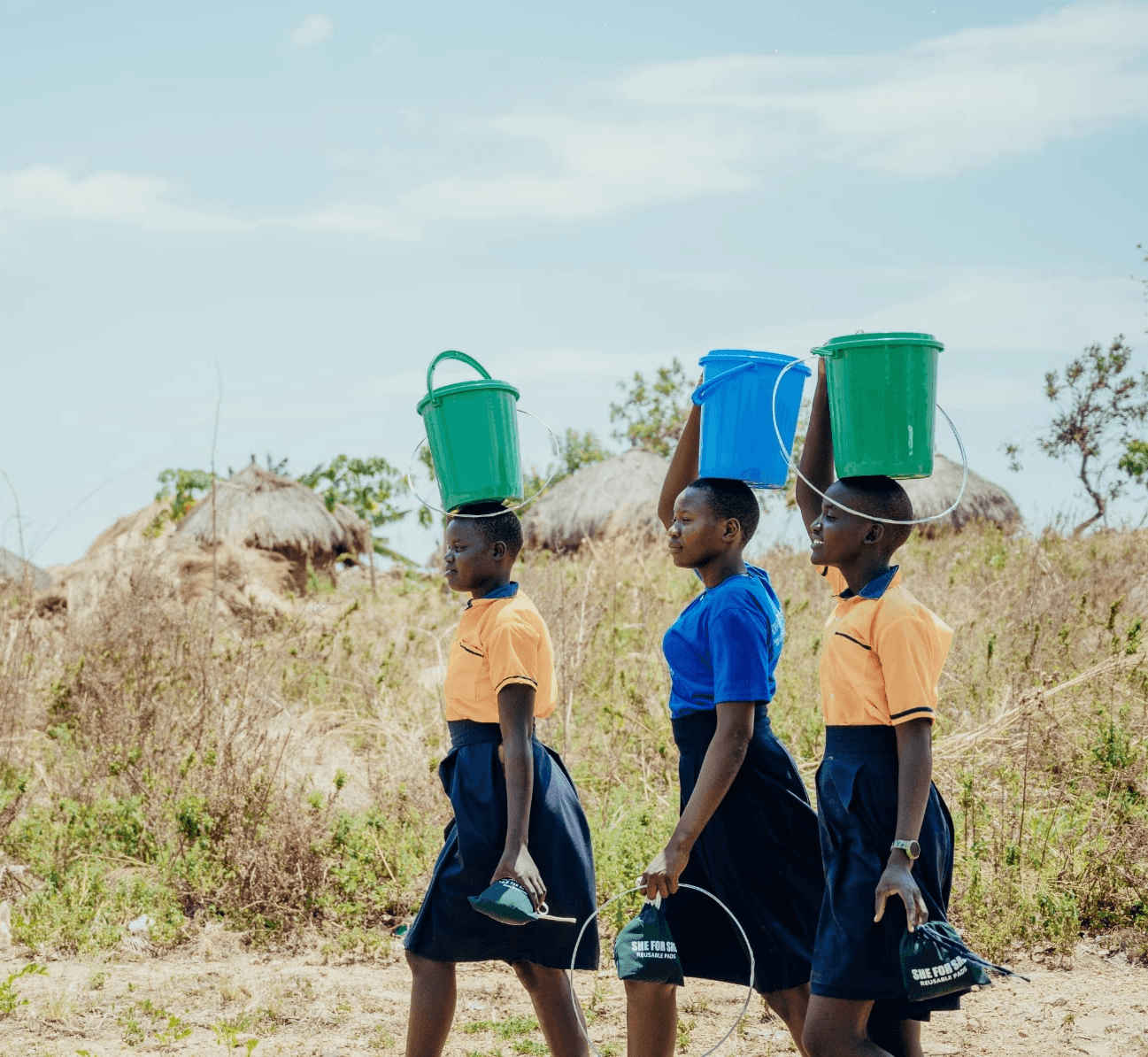 Girls walking, ready to distribute the pads