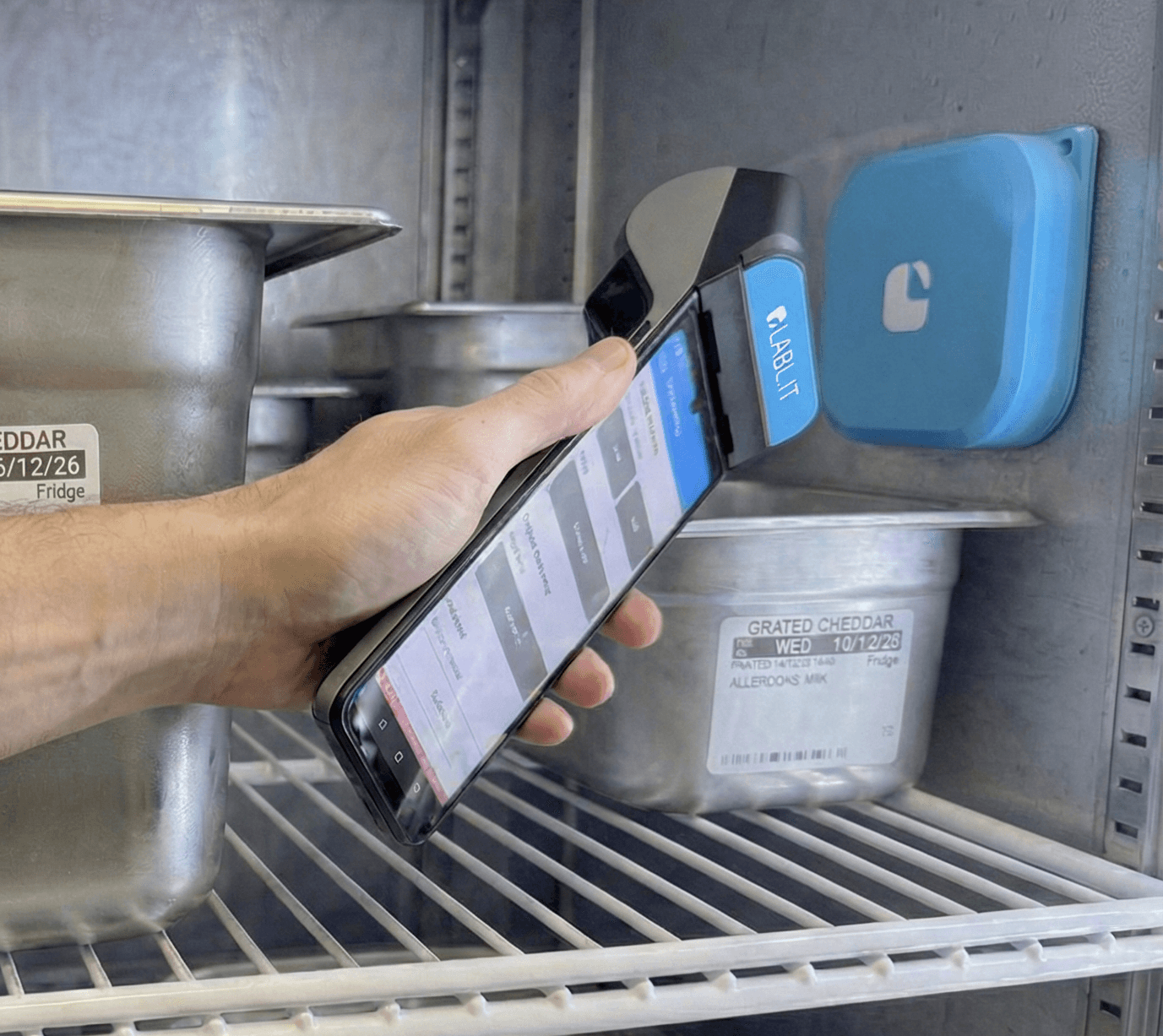 Labl.it device being tapped against TempLog Sensor on fridge wall