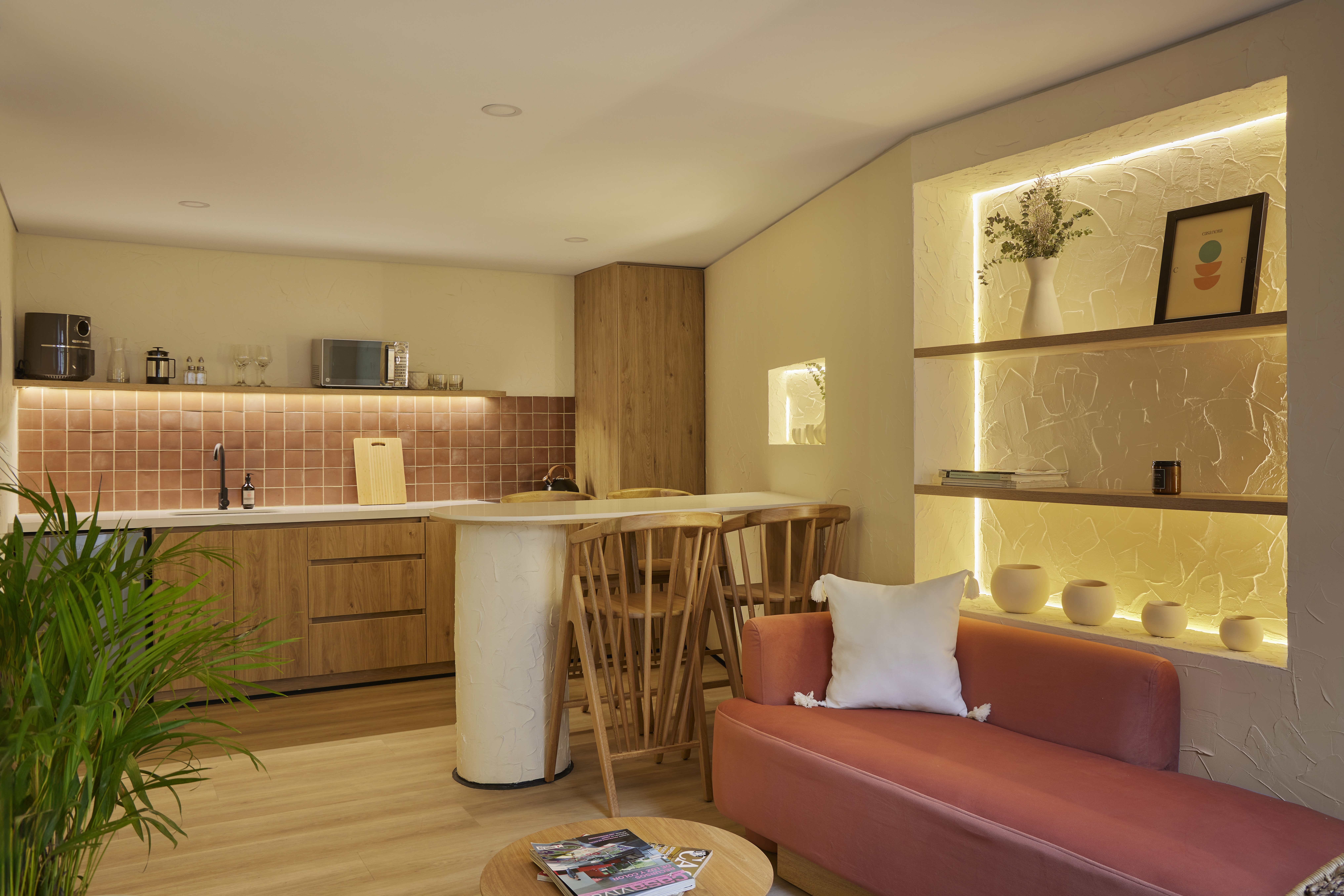 Double-height interior with flowing sculptural forms and warm raking light