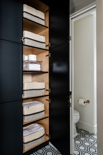 A custom cabinet in this Sammamish, Washington bathroom renovation by full service interior design firm Elegant Simplicity.