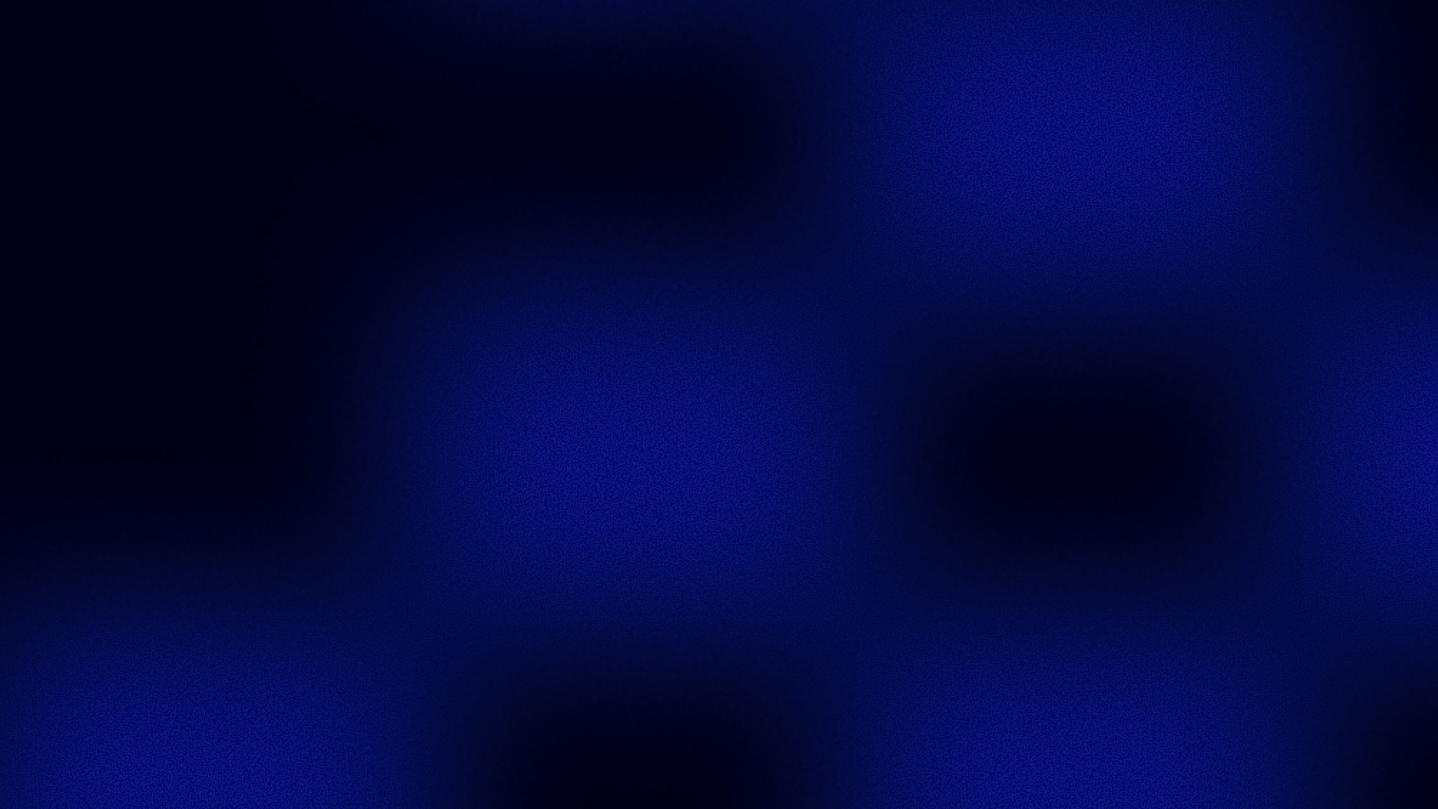 A white sphere suspended among curved black metallic ribbons.