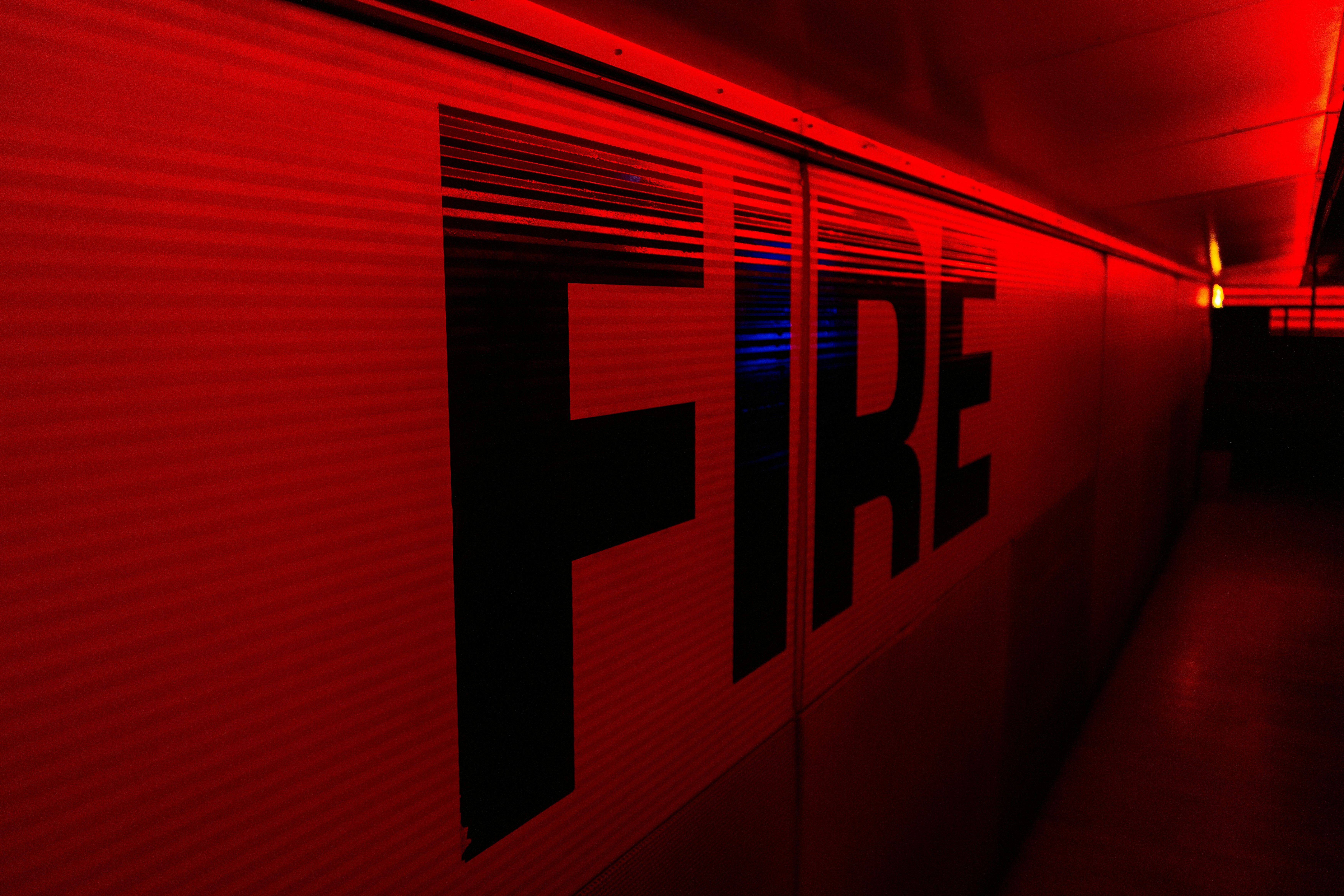 a red wall with the word fire painted on it