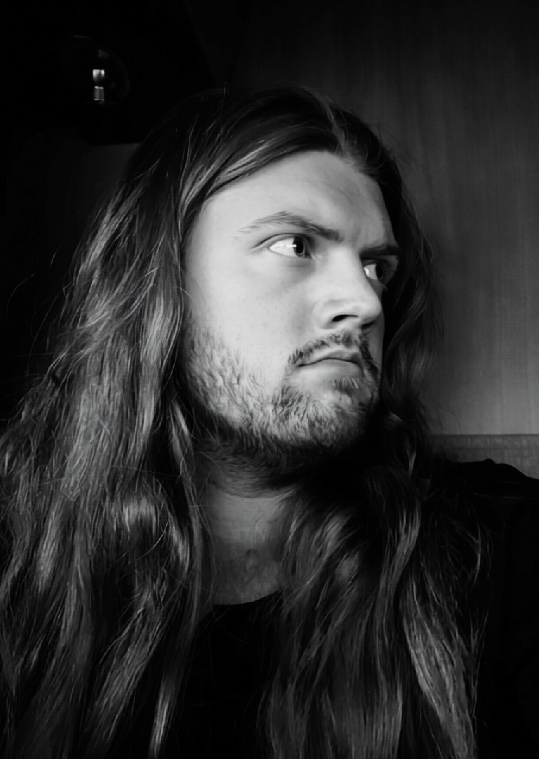 a black and white photo of a man in a sweater