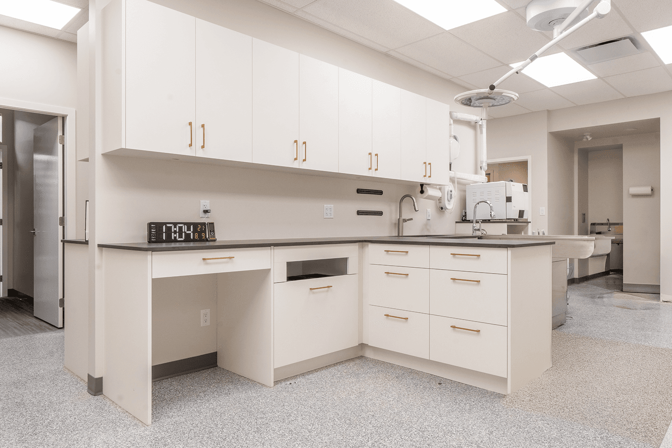 L-shaped cabinetry installation featuring soft-close drawers, upper storage, and clean medical-grade finishes.