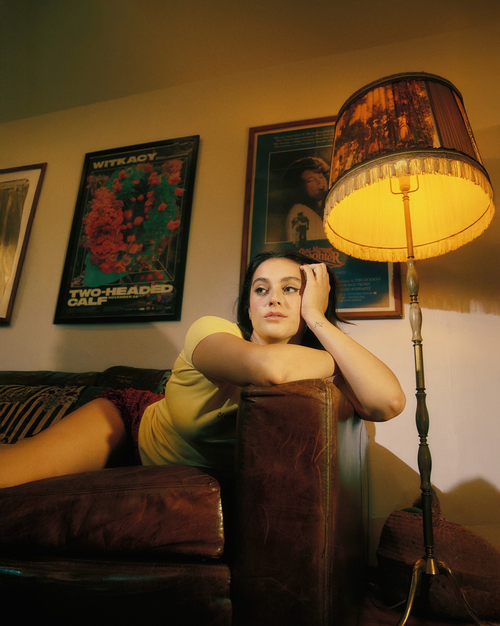 Young woman in casual clothing posing against a white background.