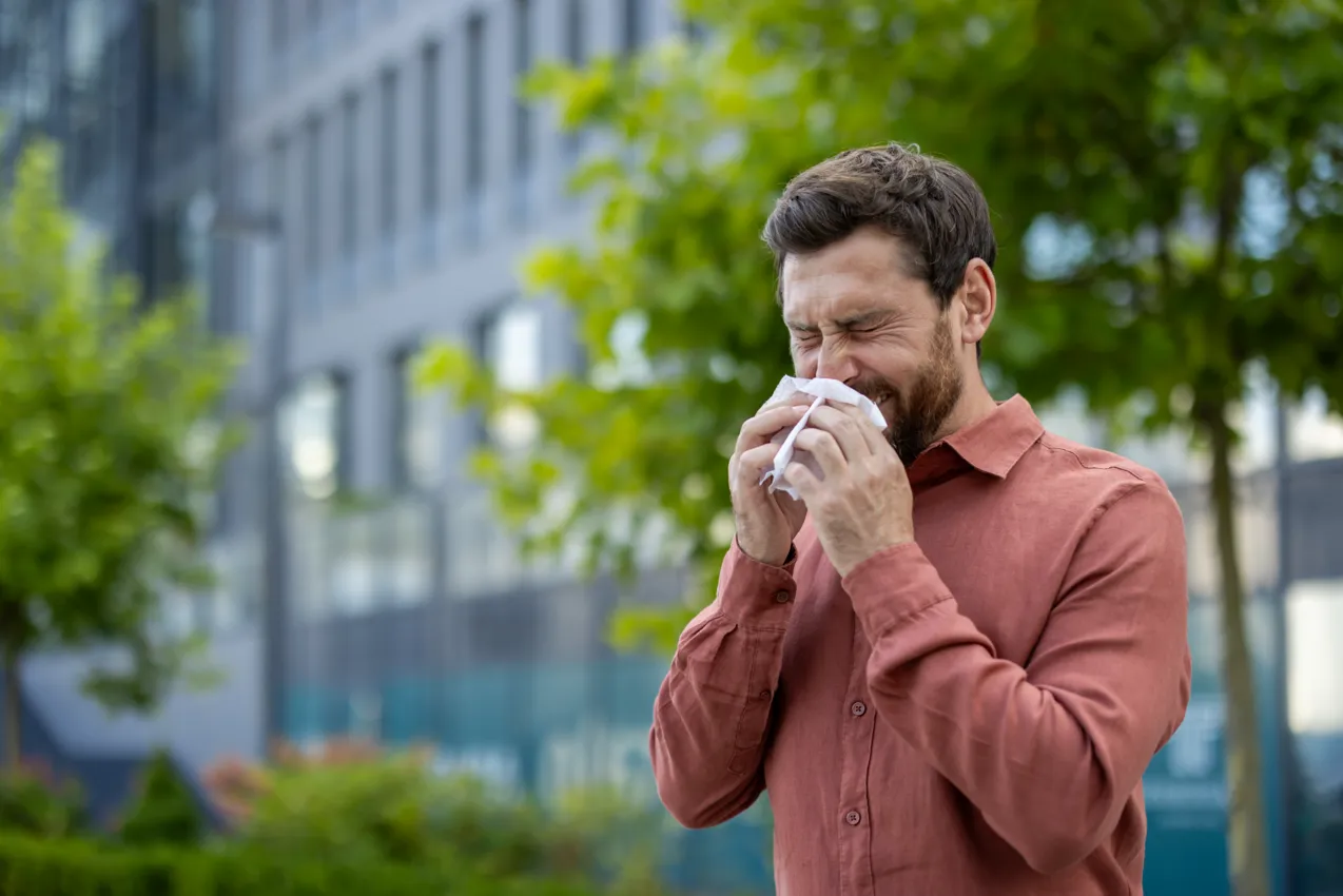 sneezing man