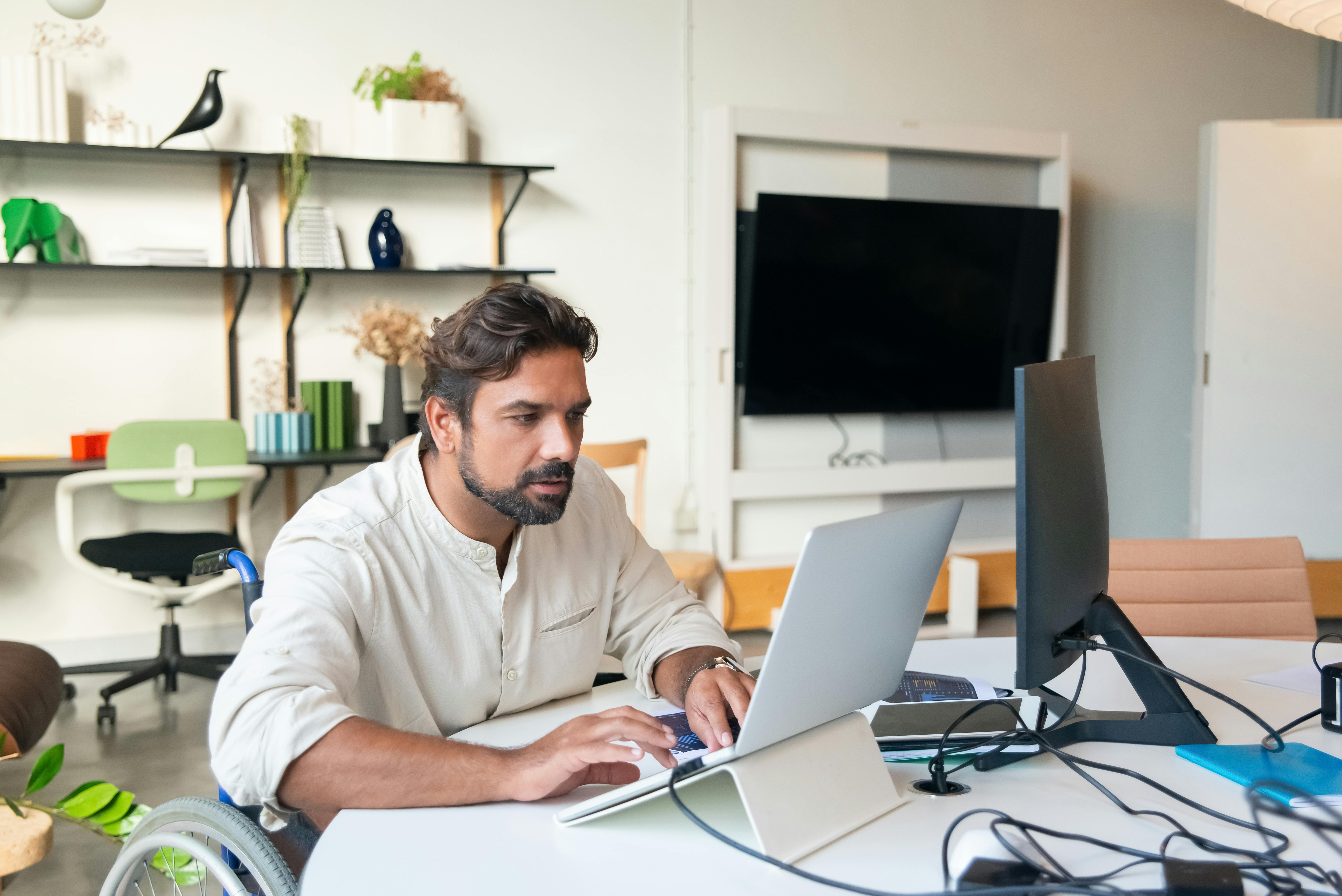 Professional working at a laptop in a bright office