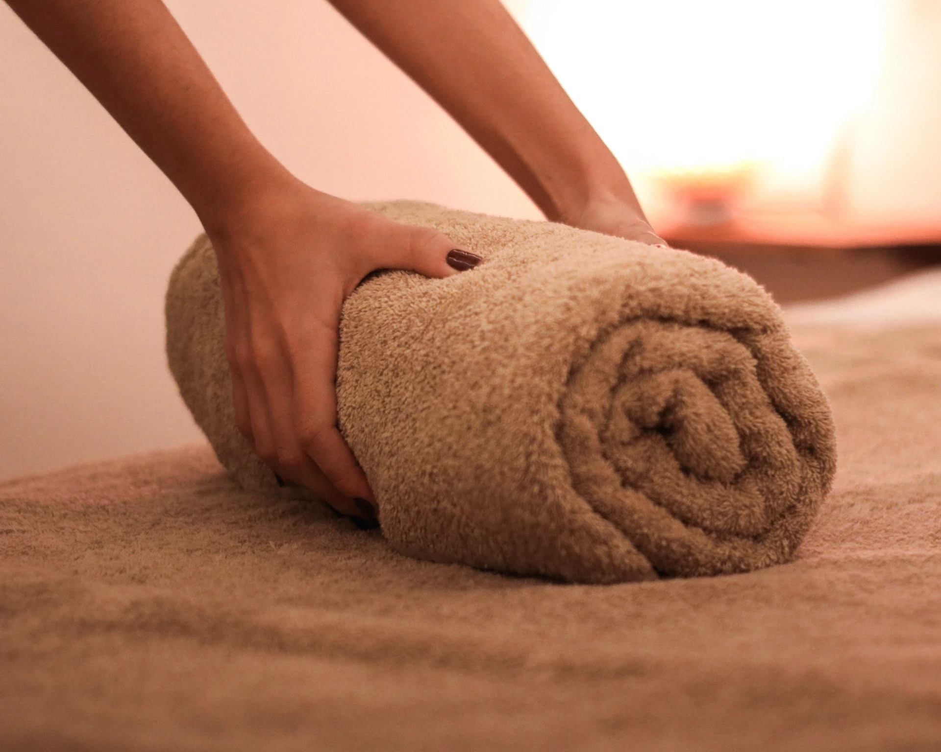Hands rolling a towel. Logo design Barcelona and brand identity designer.