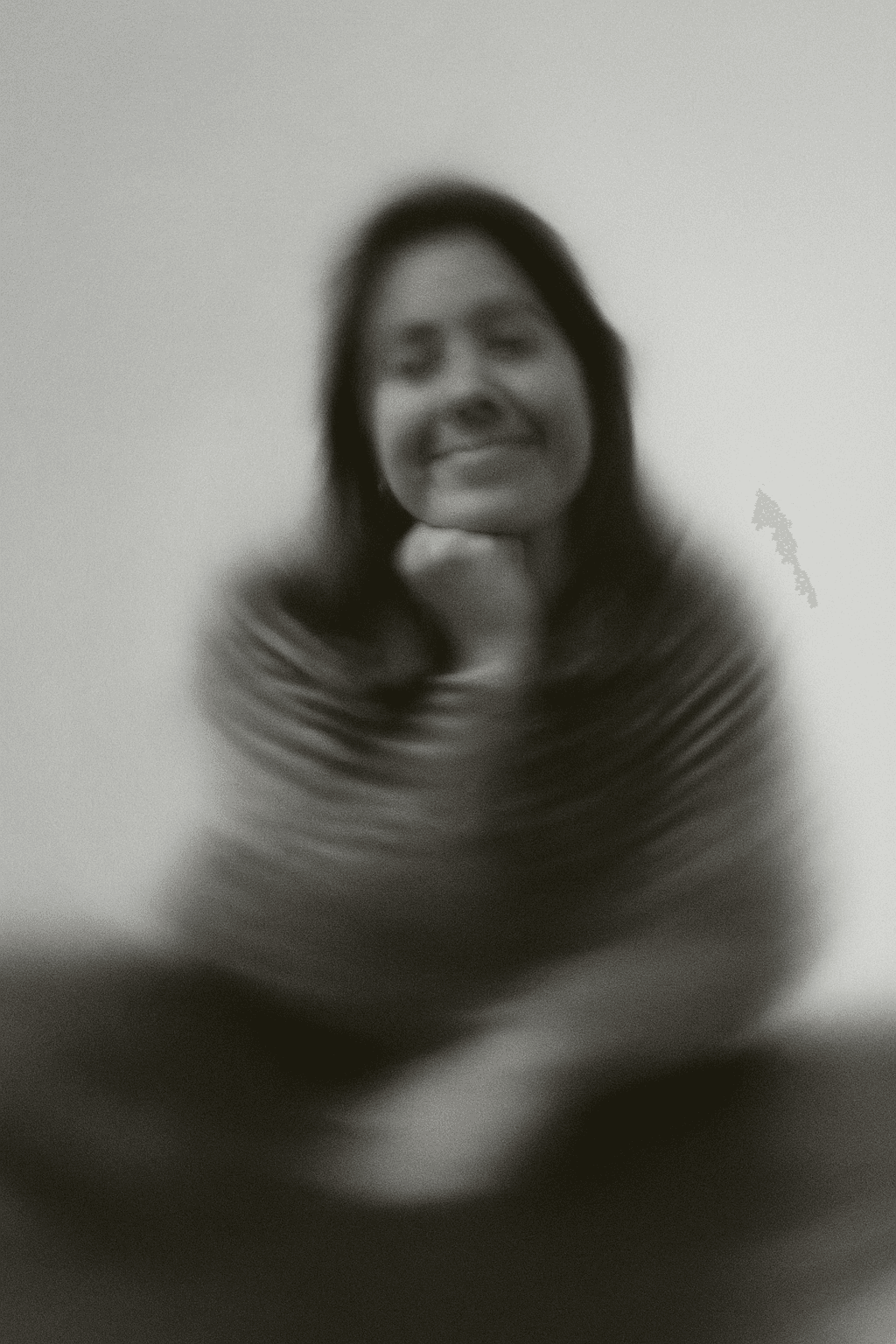 a blurry photo of a person standing in front of a wall