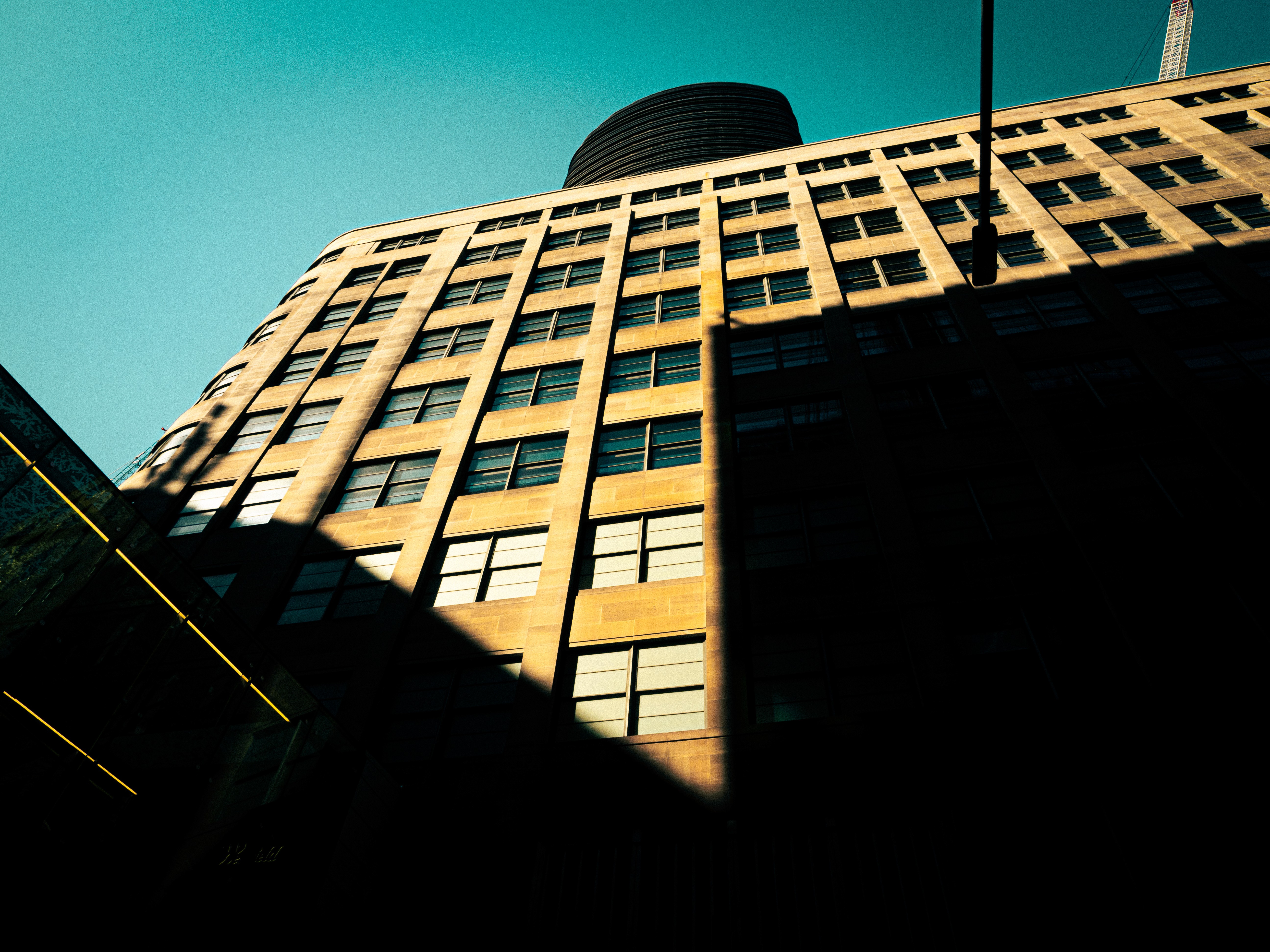 Three models standing in a wheat field, wearing beige suits.