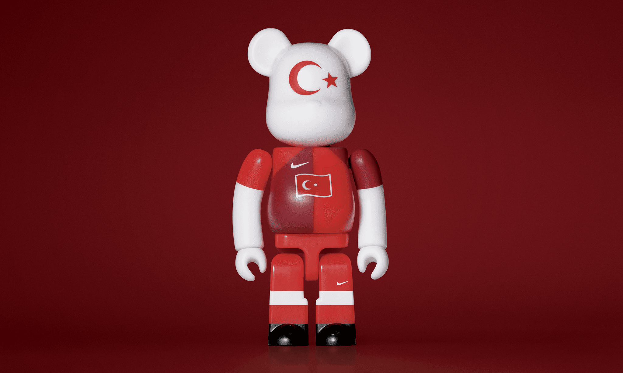 A single 3.5” tall Bre@rbrick/Nike toy created to commemorate the 2006 Turkish World Cup football team. The toy is painted to appear in the Turkish football kit and stands in the center of the frame in front of a dark red background.