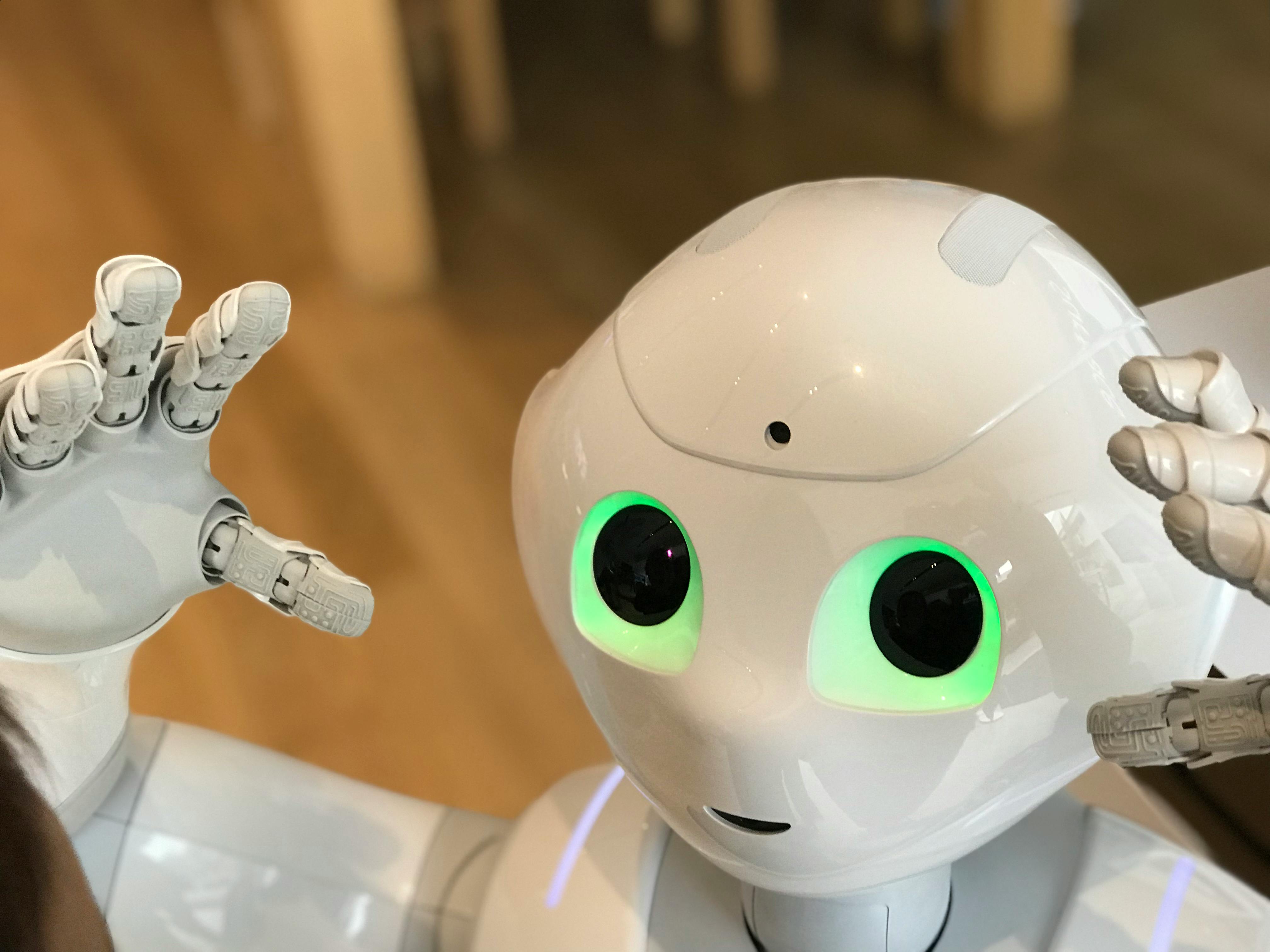 man in black crew neck t-shirt wearing black sunglasses holding black smartphone