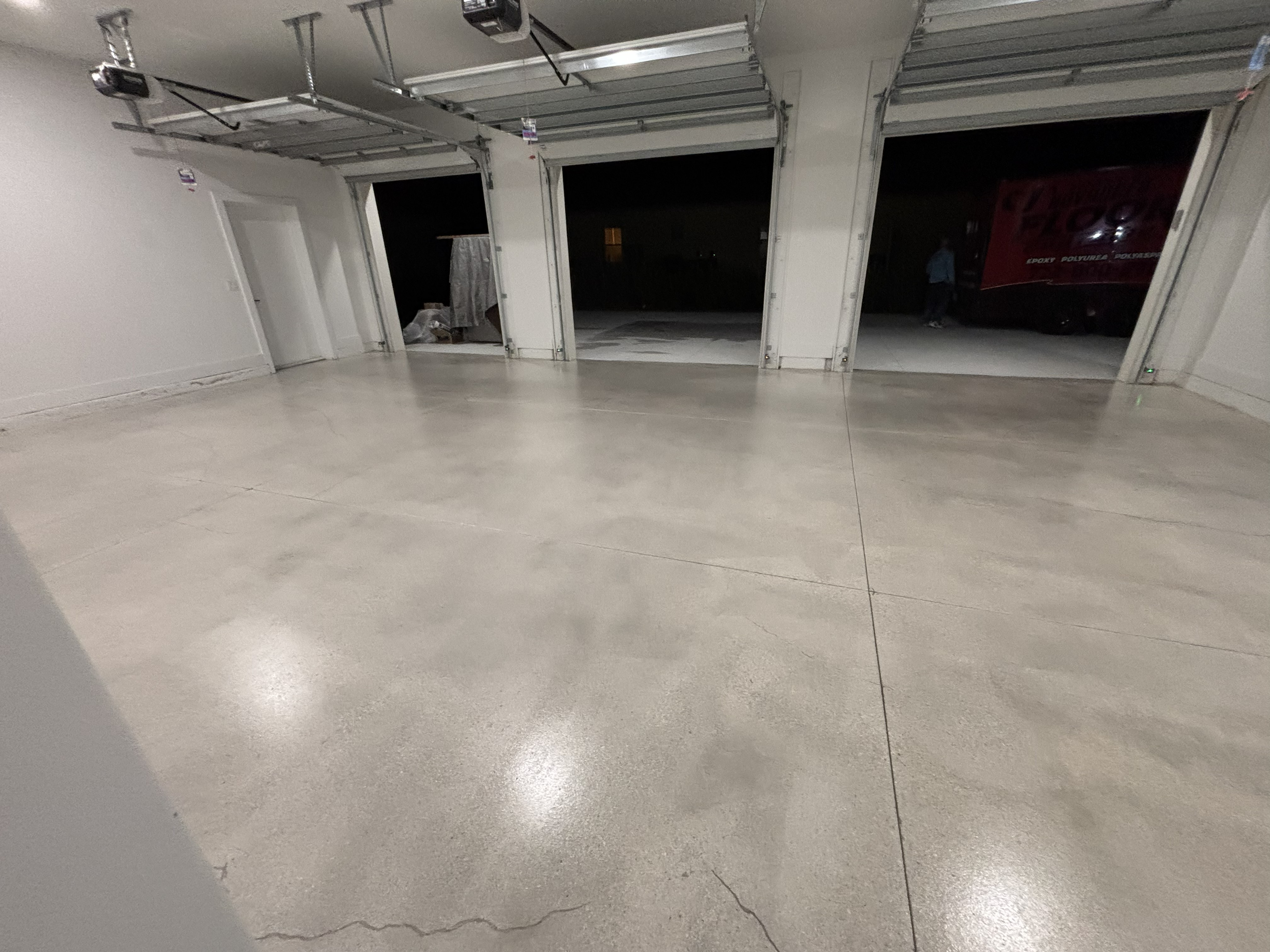 Three-car garage with a refined grind-and-seal concrete floor