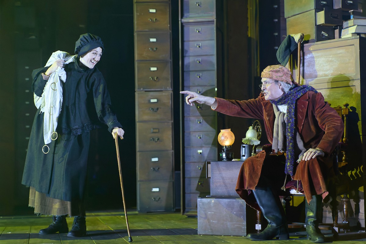 A Christmas Carol moment with Scrooge pointing at a visitor in his office.