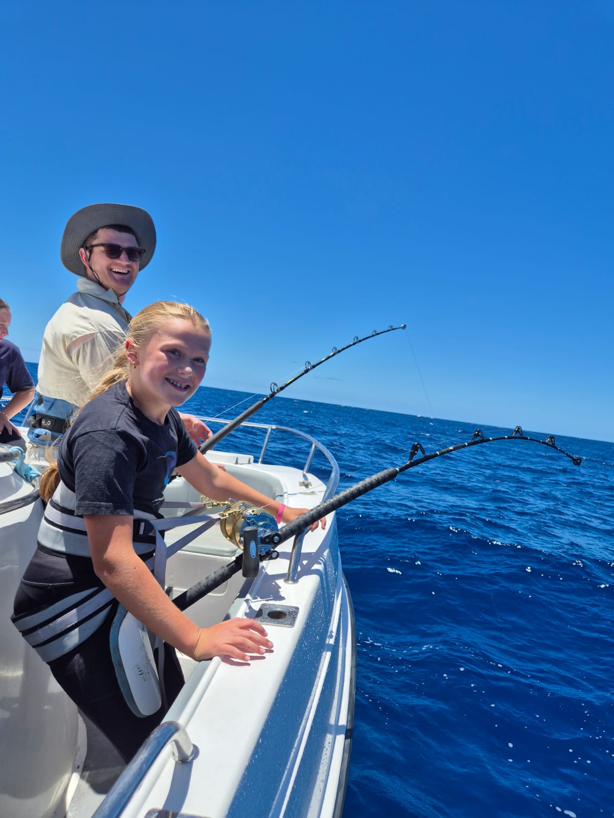 Private fishing experience with guests catching yellowfin tuna.