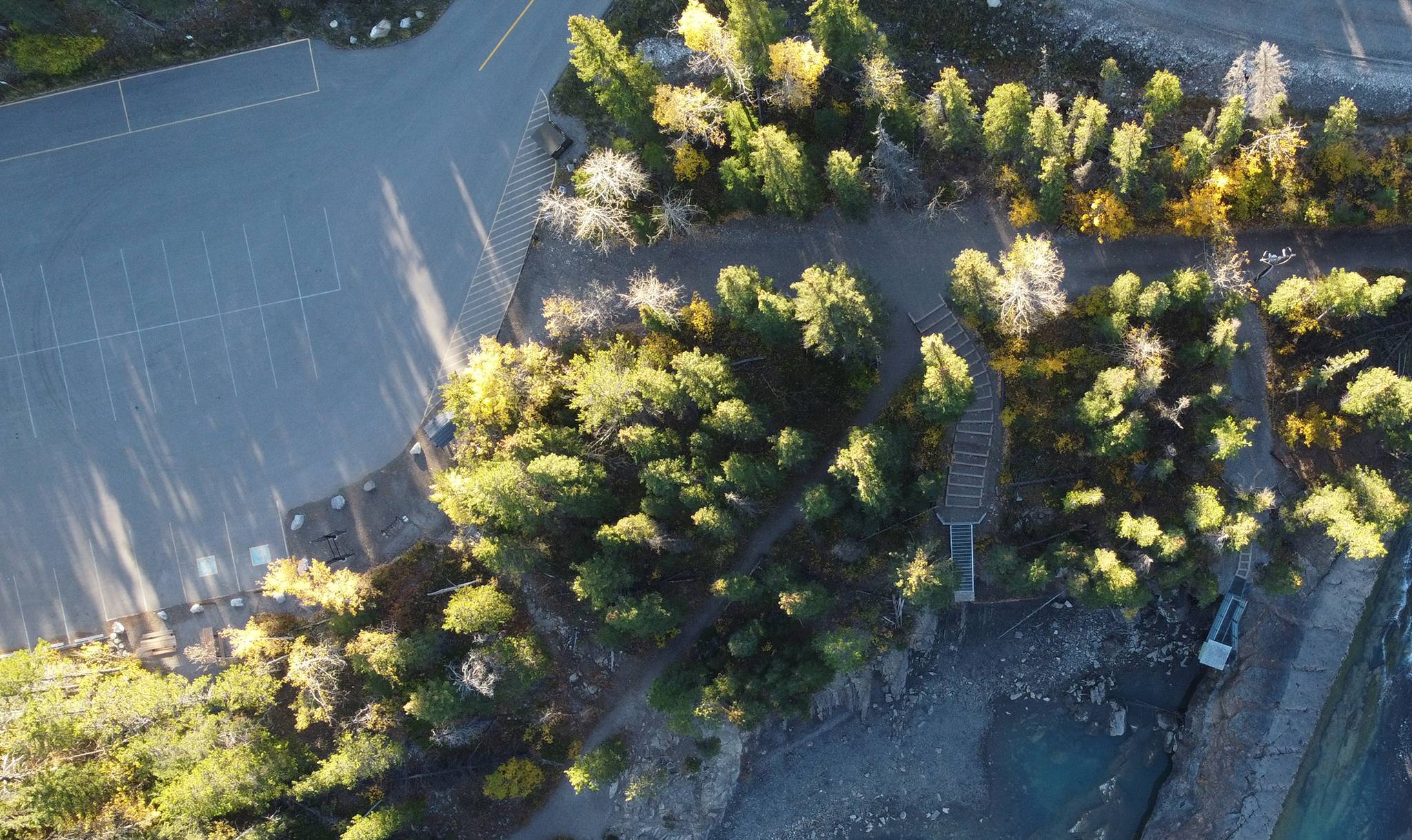 Aerial view of Widowmaker parking area with accessible stairway to Kananaskis River in autumn