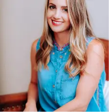 smiling girl in blue sleeveless dress