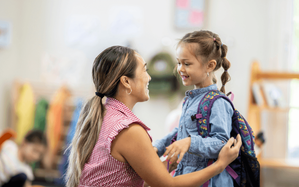 Mother dropping daughter off at school, showing how Kina helps **earn rewards on parenting expenses