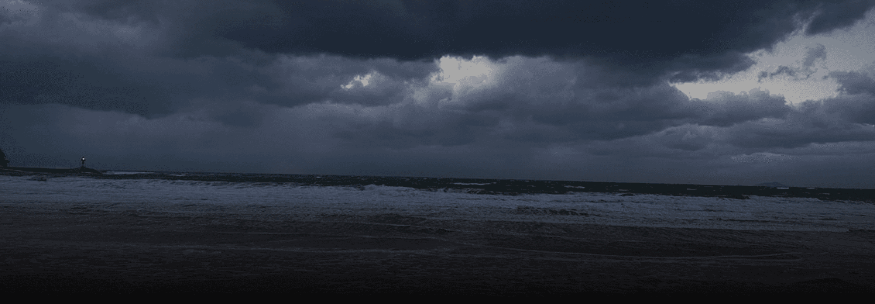 Atmospheric background image of a dark, stormy sea crashing onto a desolate beach under heavy gray clouds, used as the hero image for the Blackwood template Privacy Policy page.