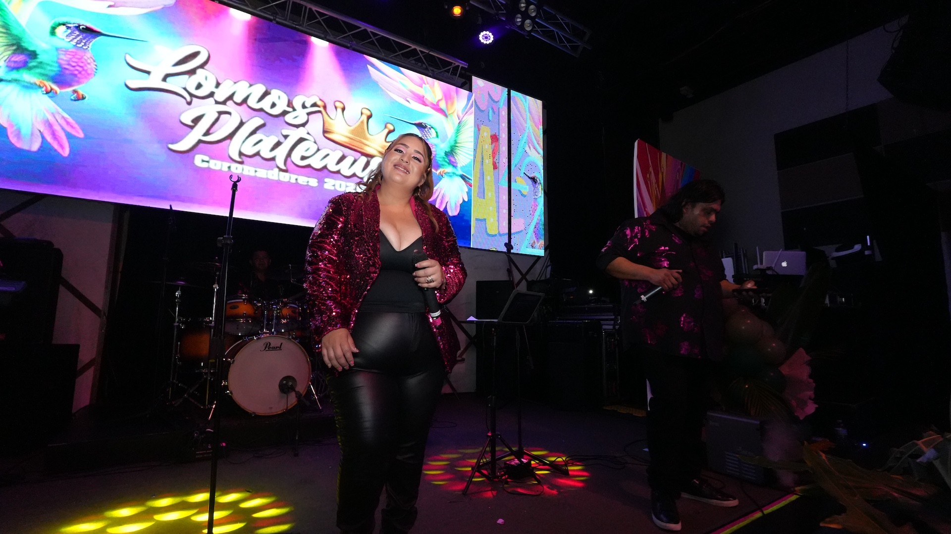 Three women holding hands at outdoor event