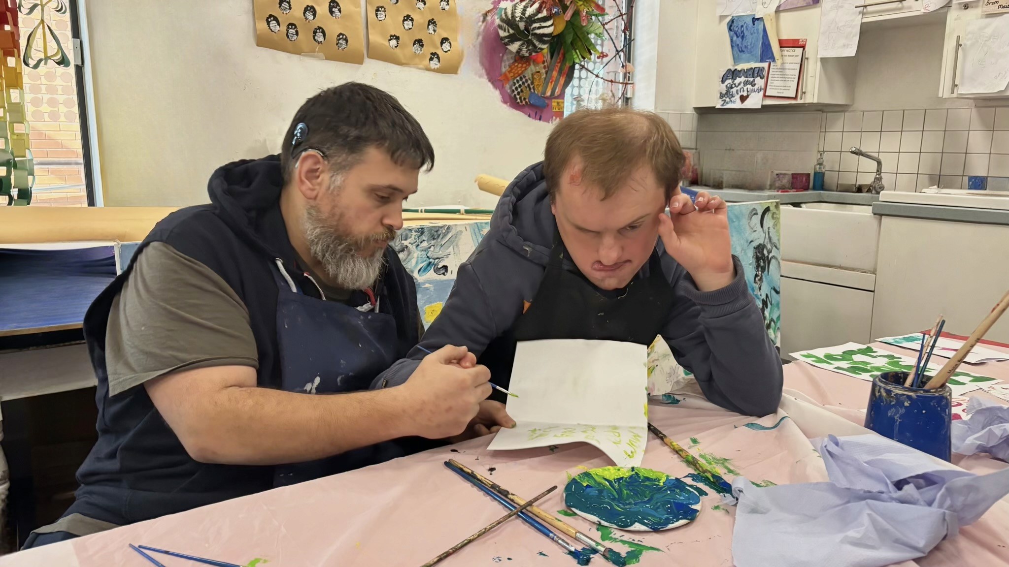 support-worker-communicating-with-client-art-room