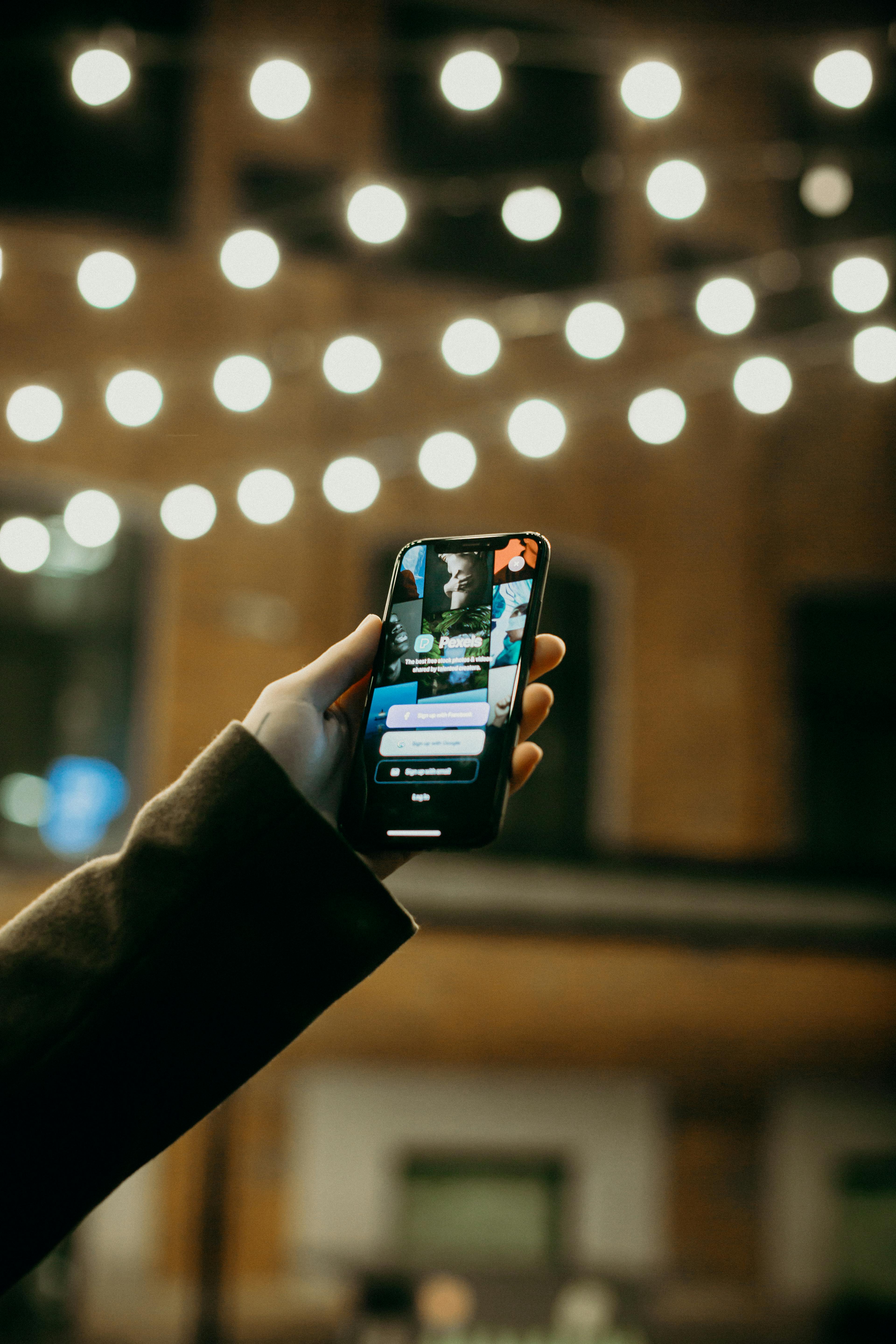 An image of a phone in a hand, showing an app | User Experience