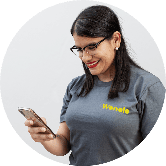 A person wearing a Wonolo branded t-shirt looking at a mobile phone