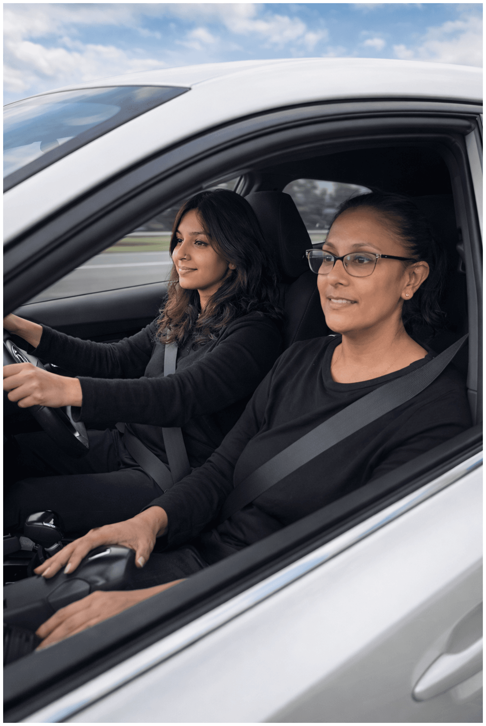 Auto-Learners driving instructor explaining a lesson to a learner beside a car