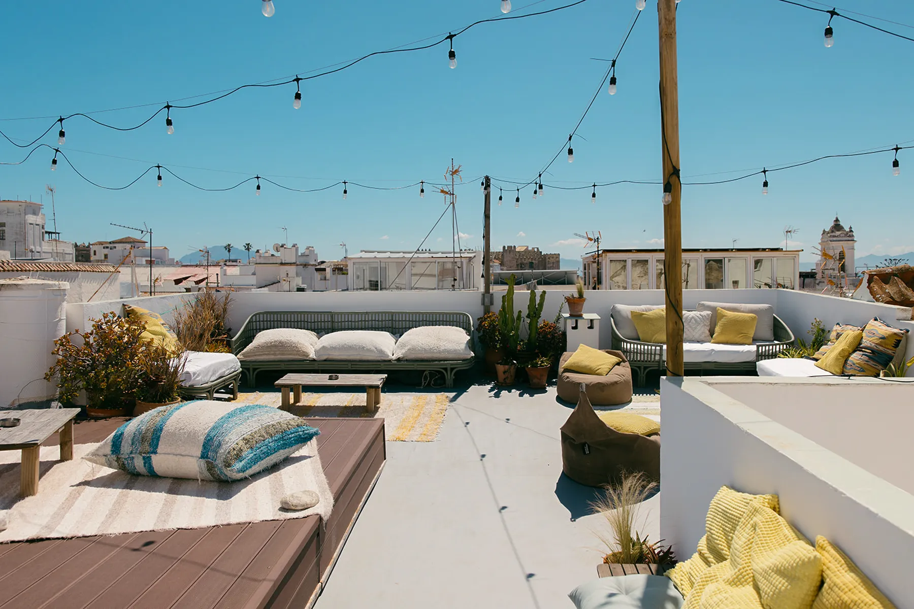 Rooftop lounge with city views and cozy seating – find your perfect accommodation in Tarifa with laid-back surf house charm